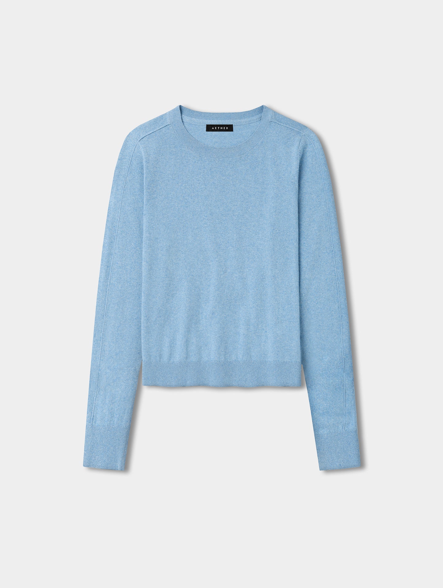 Flat lay view of the women’s Aero Crewneck Sweater 2.0 in Cloud Blue from AETHER Apparel.