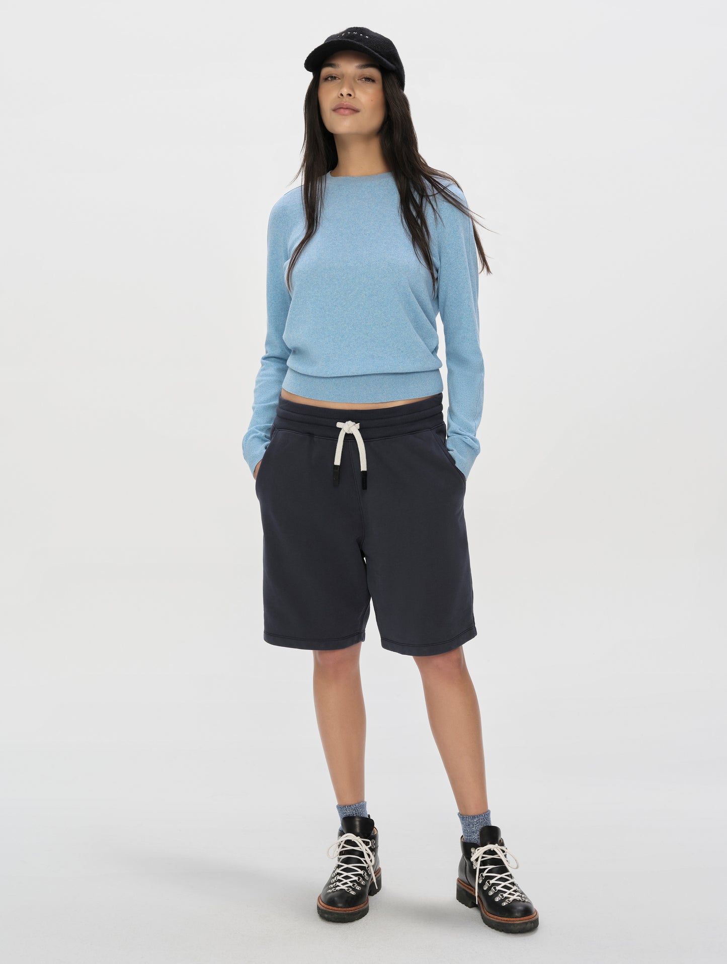 Front, full-body view of woman wearing the Aero Crewneck Sweater 2.0 in Cloud Blue from AETHER Apparel.