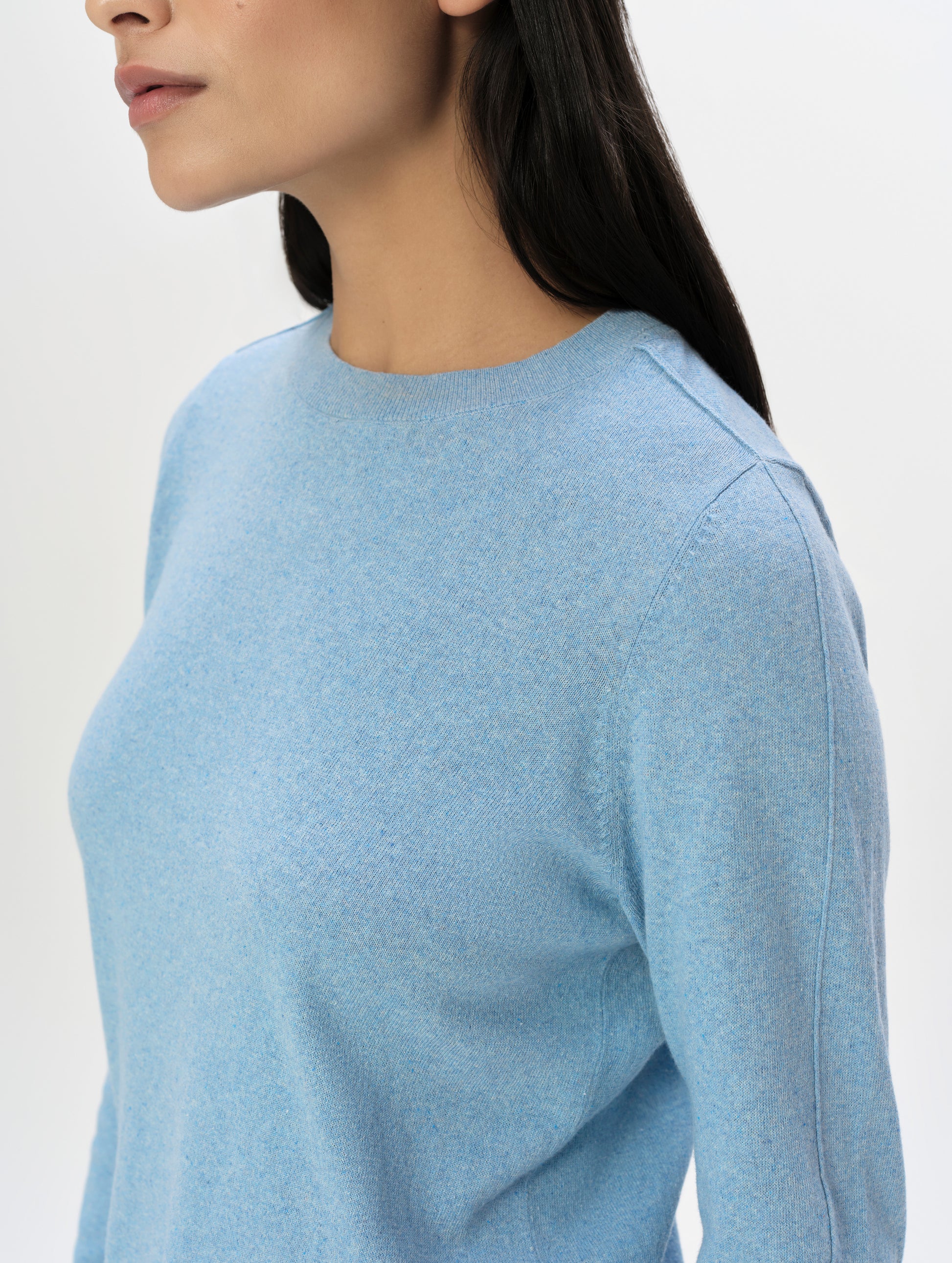 Closeup detailed 3/4 view of the women's Aero Crewneck Sweater 2.0 in Cloud Blue from AETHER Apparel.