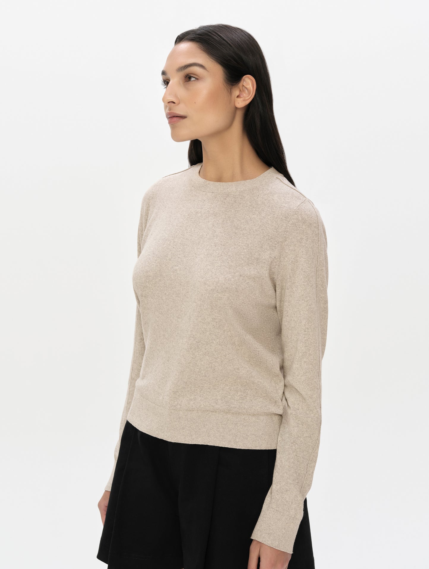 Front, 3/4 upper-body view of woman wearing the Aero Crewneck Sweater 2.0 in Lino Tan from AETHER Apparel.