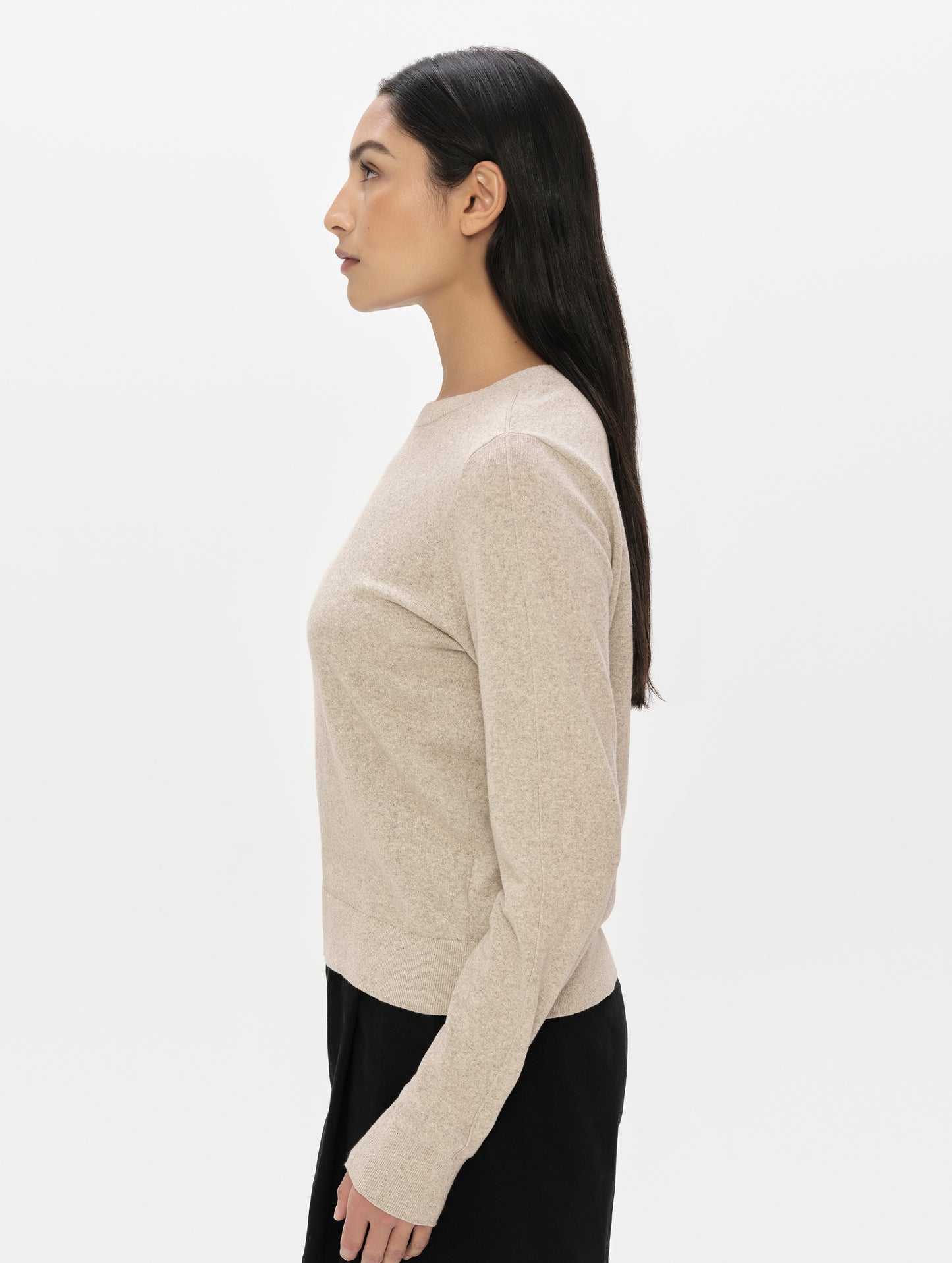 Side profile, upper-body view of woman wearing the Aero Crewneck Sweater 2.0 in Lino Tan from AETHER Apparel.