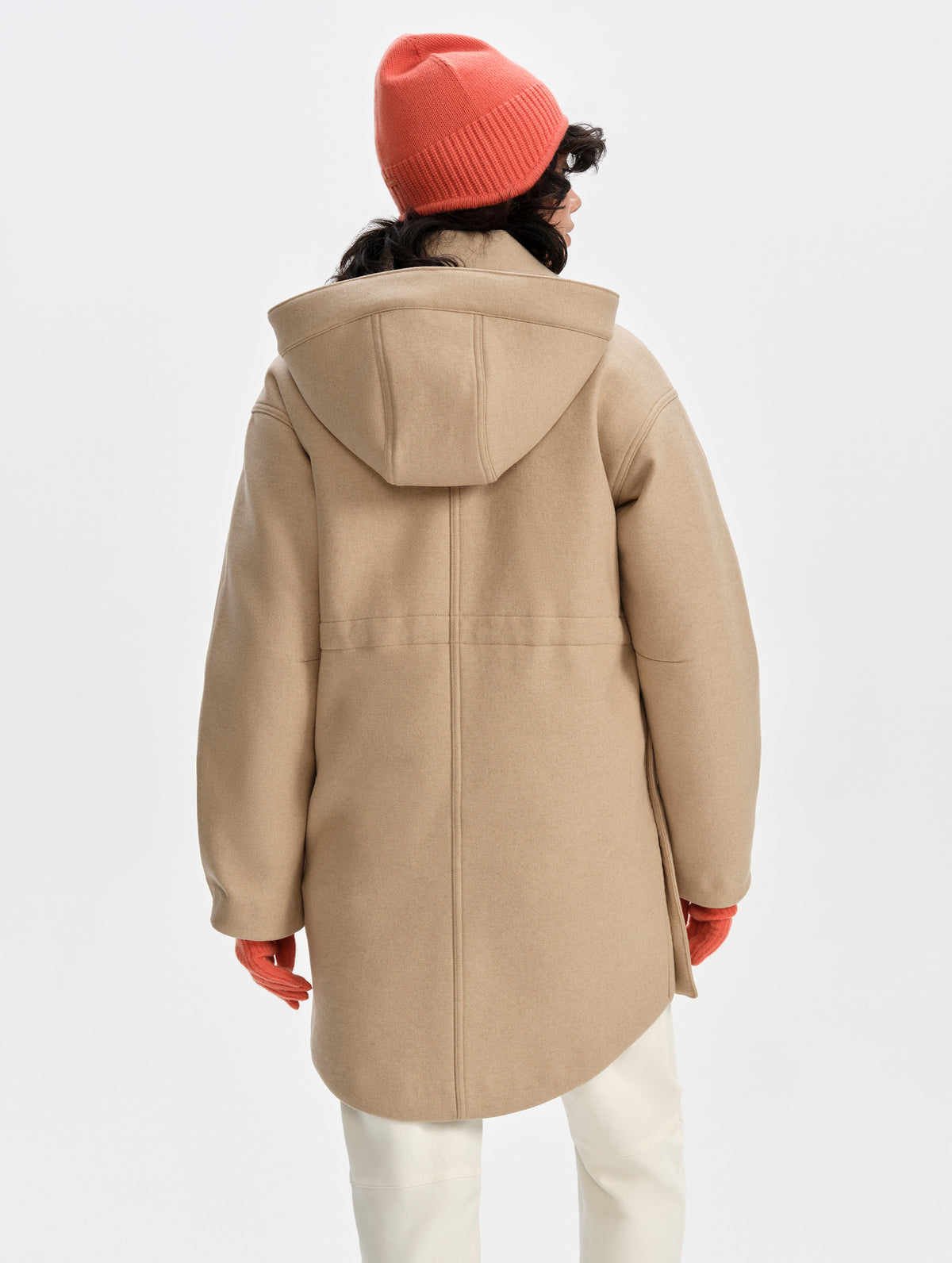 Rear upper-body view of woman wearing Affina Wool 3-in-1 Overcoat in Latte Brown from AETHER Apparel with the internal bungee waist uncinched.