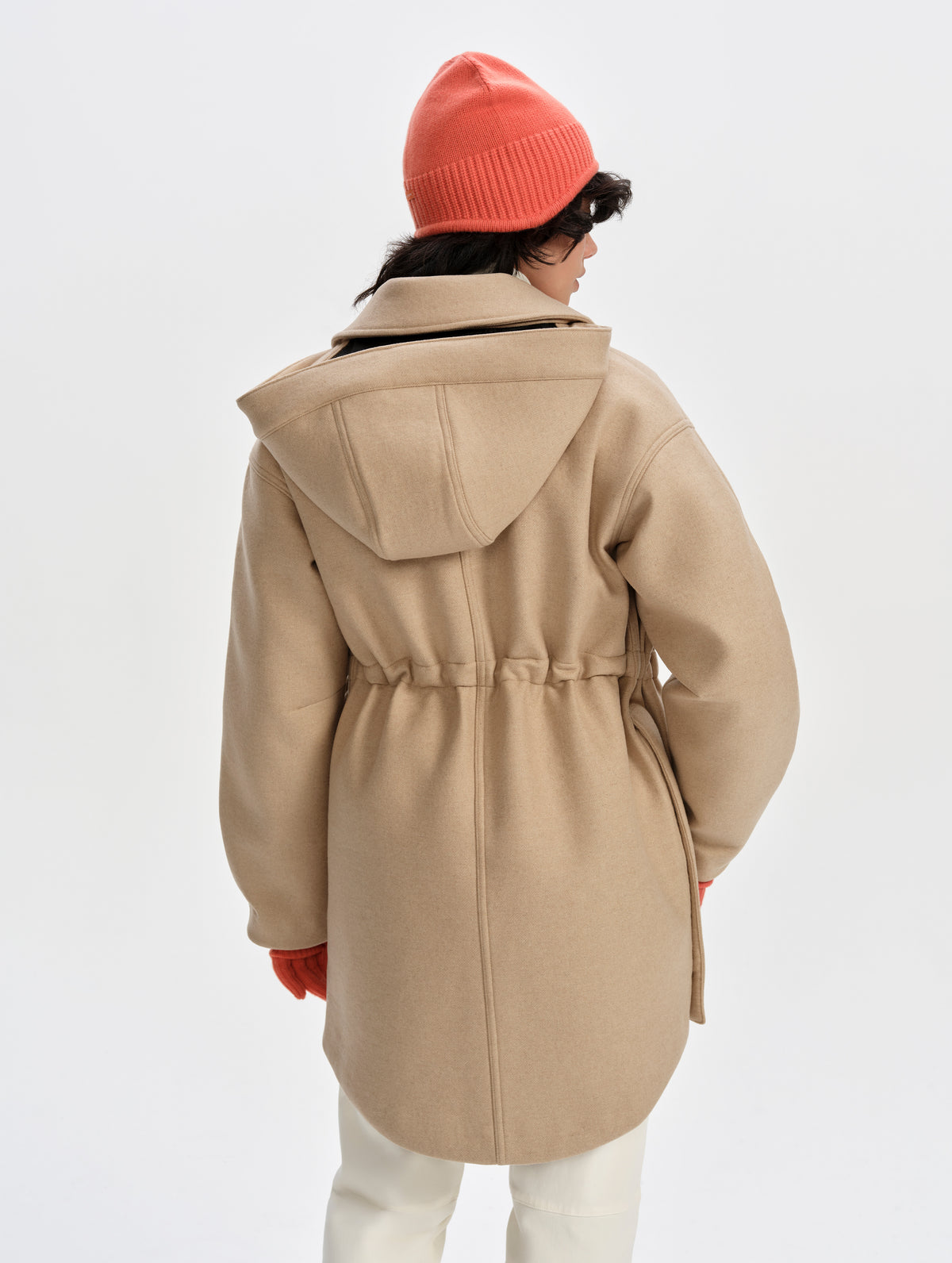 Rear upper-body view of woman wearing Affina Wool 3-in-1 Overcoat in Latte Brown from AETHER Apparel with the internal bungee waist cinched.
