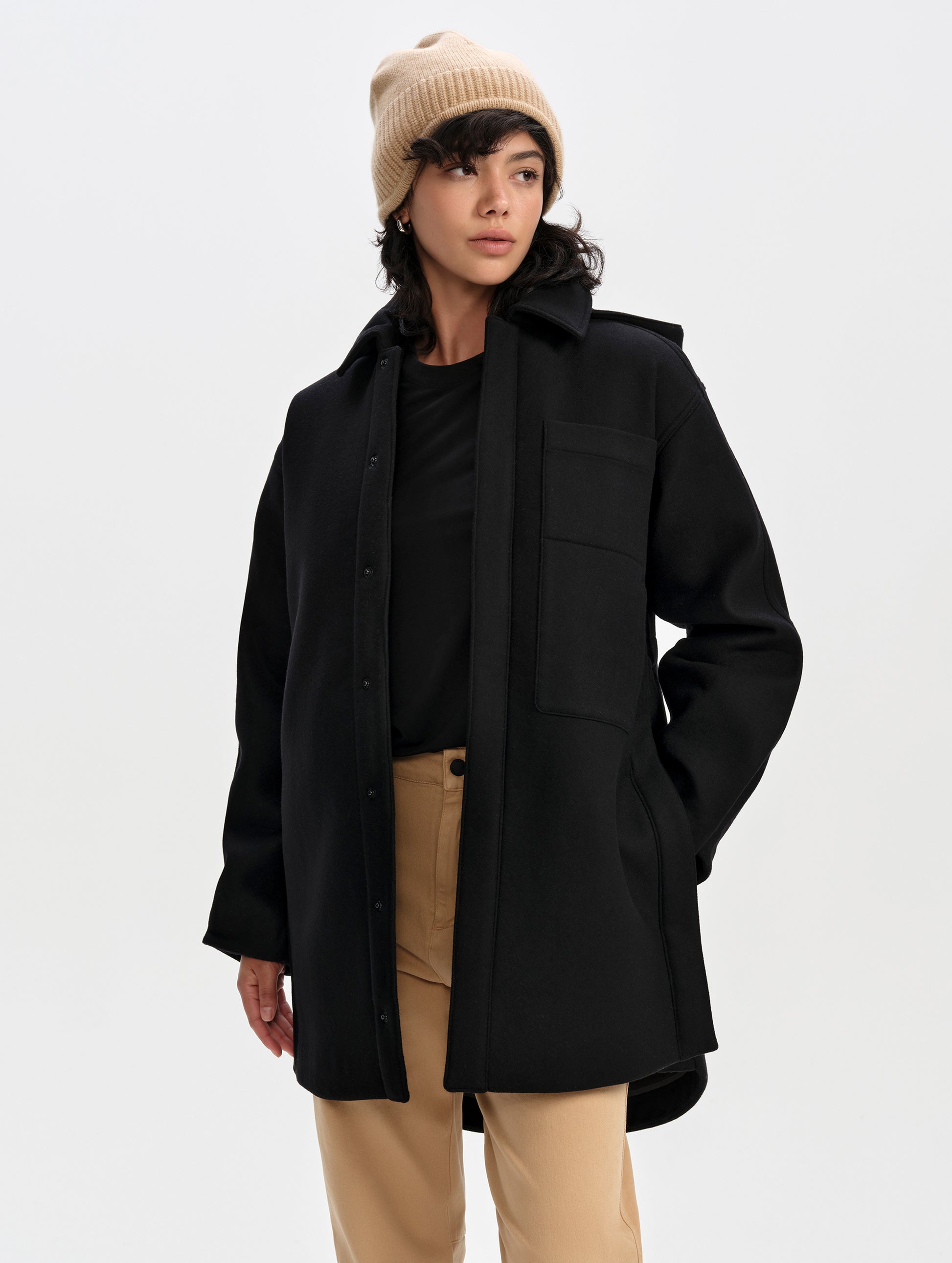 Front upper-body view of woman wearing Affina Wool 3-in-1 Overcoat in Onyx Black from AETHER Apparel.