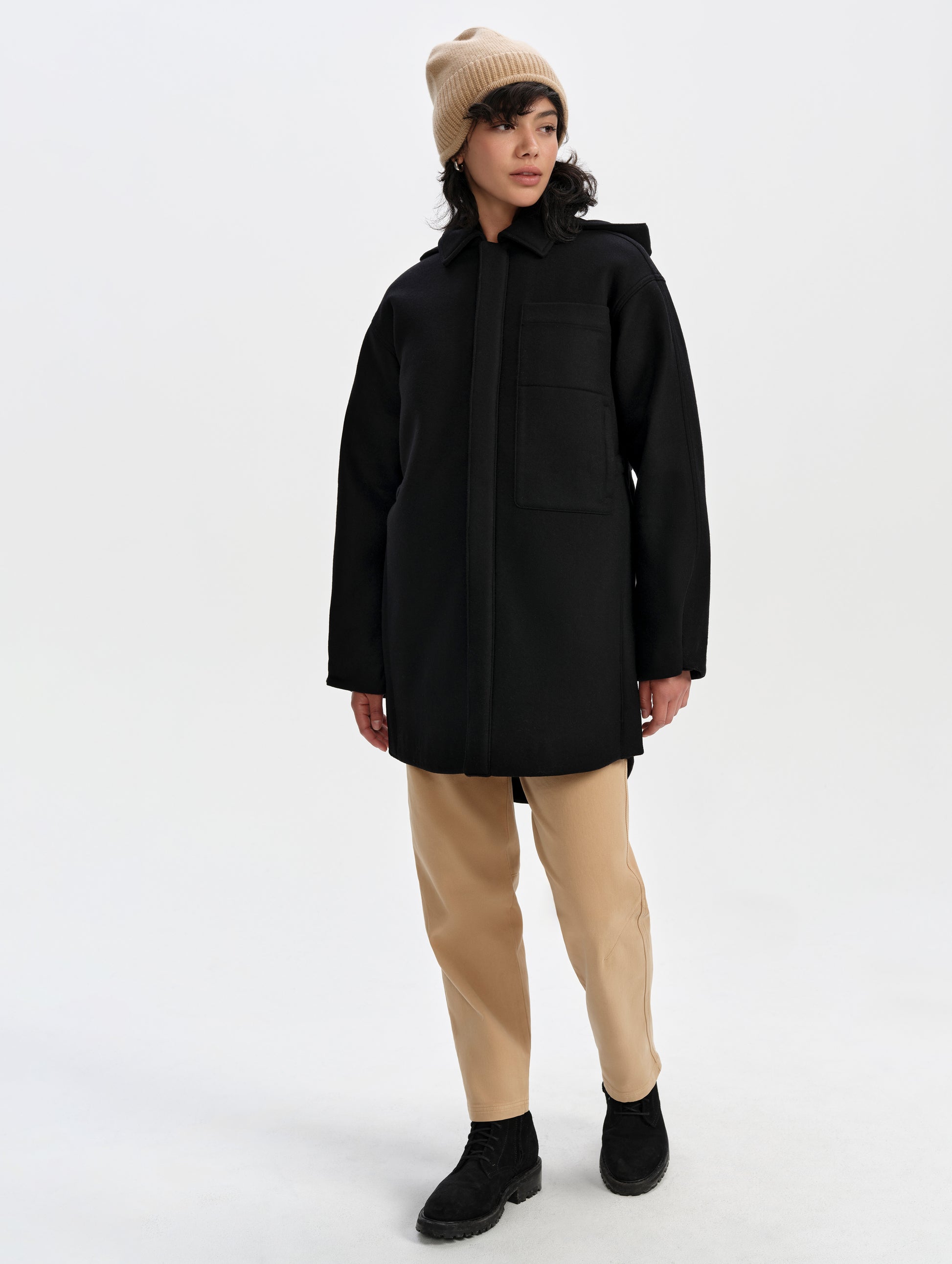 Front full-body view of woman wearing Affina Wool 3-in-1 Overcoat in Onyx Black from AETHER Apparel.