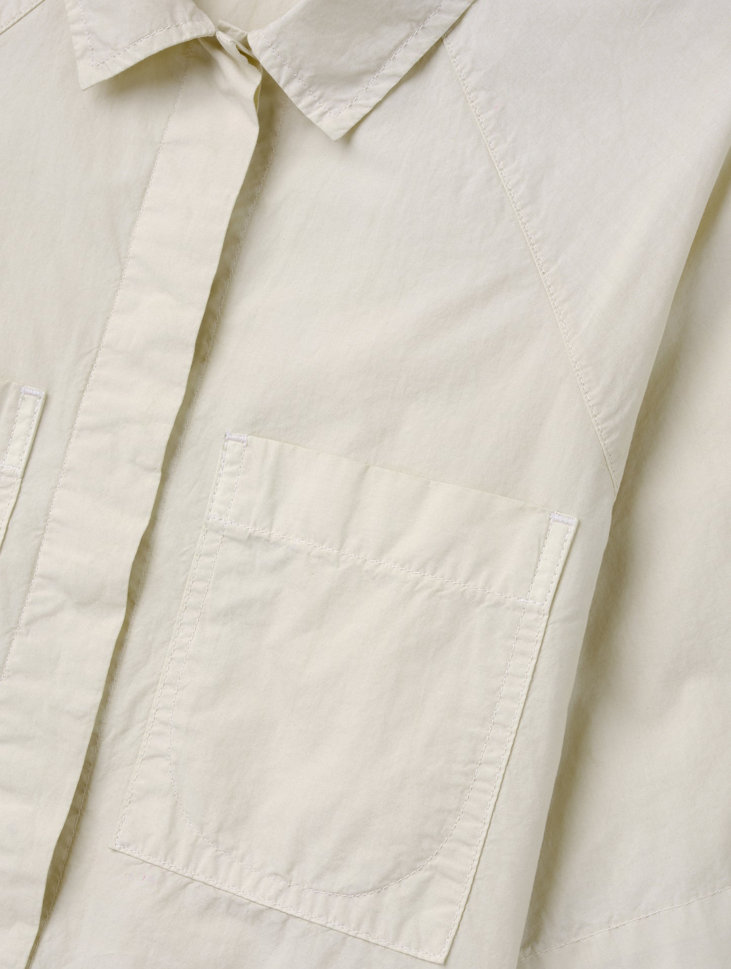 Closeup detailed view of the patch pockets on the Alice Shirt in Bone from AETHER Apparel.