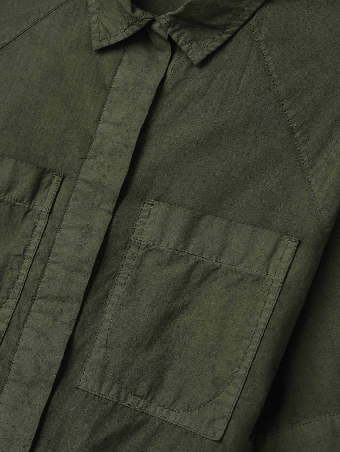 Closeup detailed view of the patch pockets on the Alice Shirt in Forest Green from AETHER Apparel.
