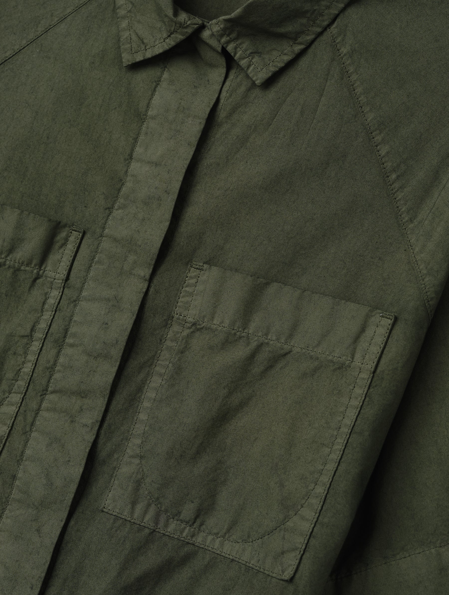 Closeup detailed view of the patch pockets on the Alice Shirt in Forest Green from AETHER Apparel.