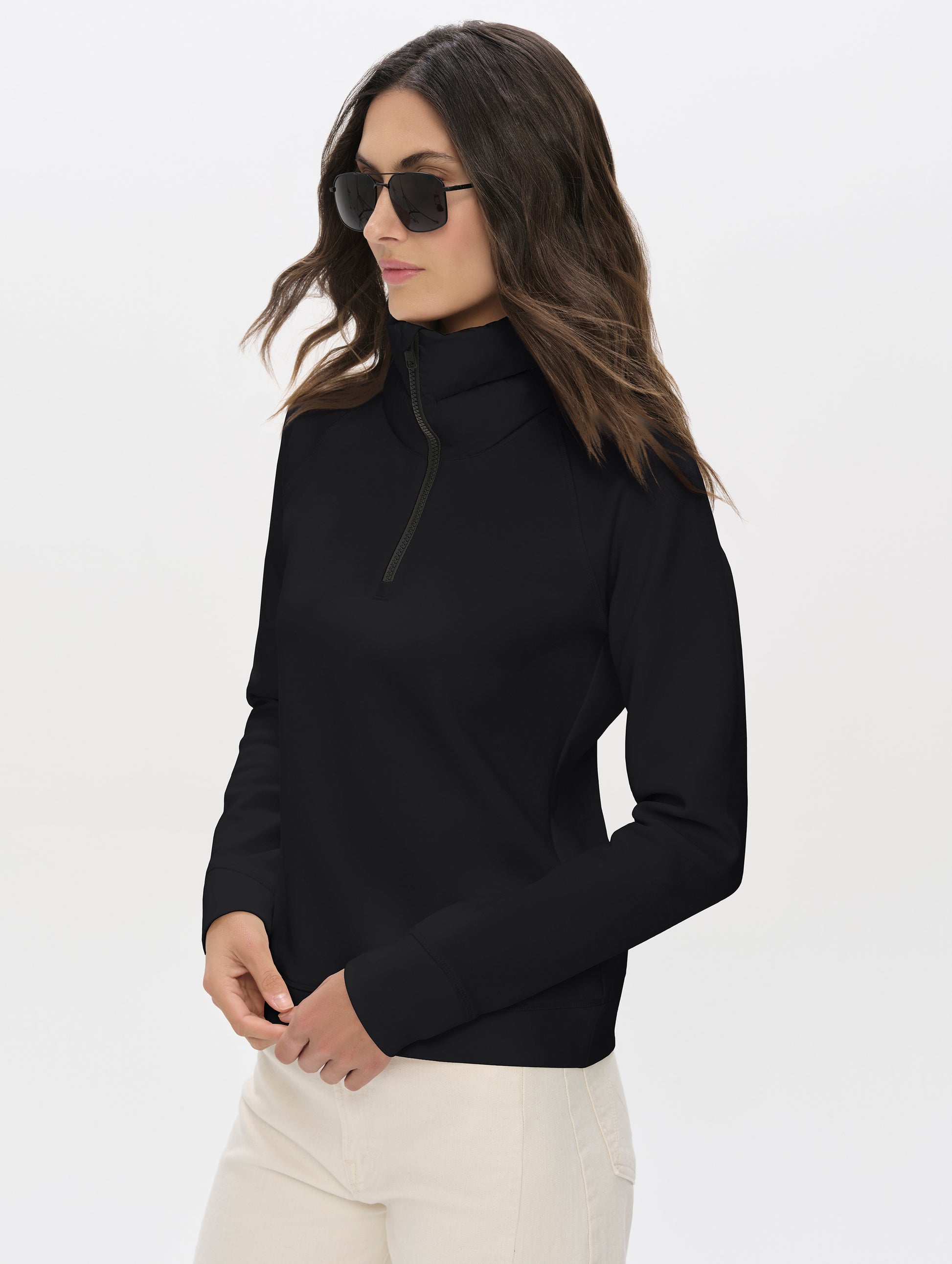 Front angled upper-body view of woman wearing Align Half-Zip Pullover in Onyx Black from AETHER Apparel.