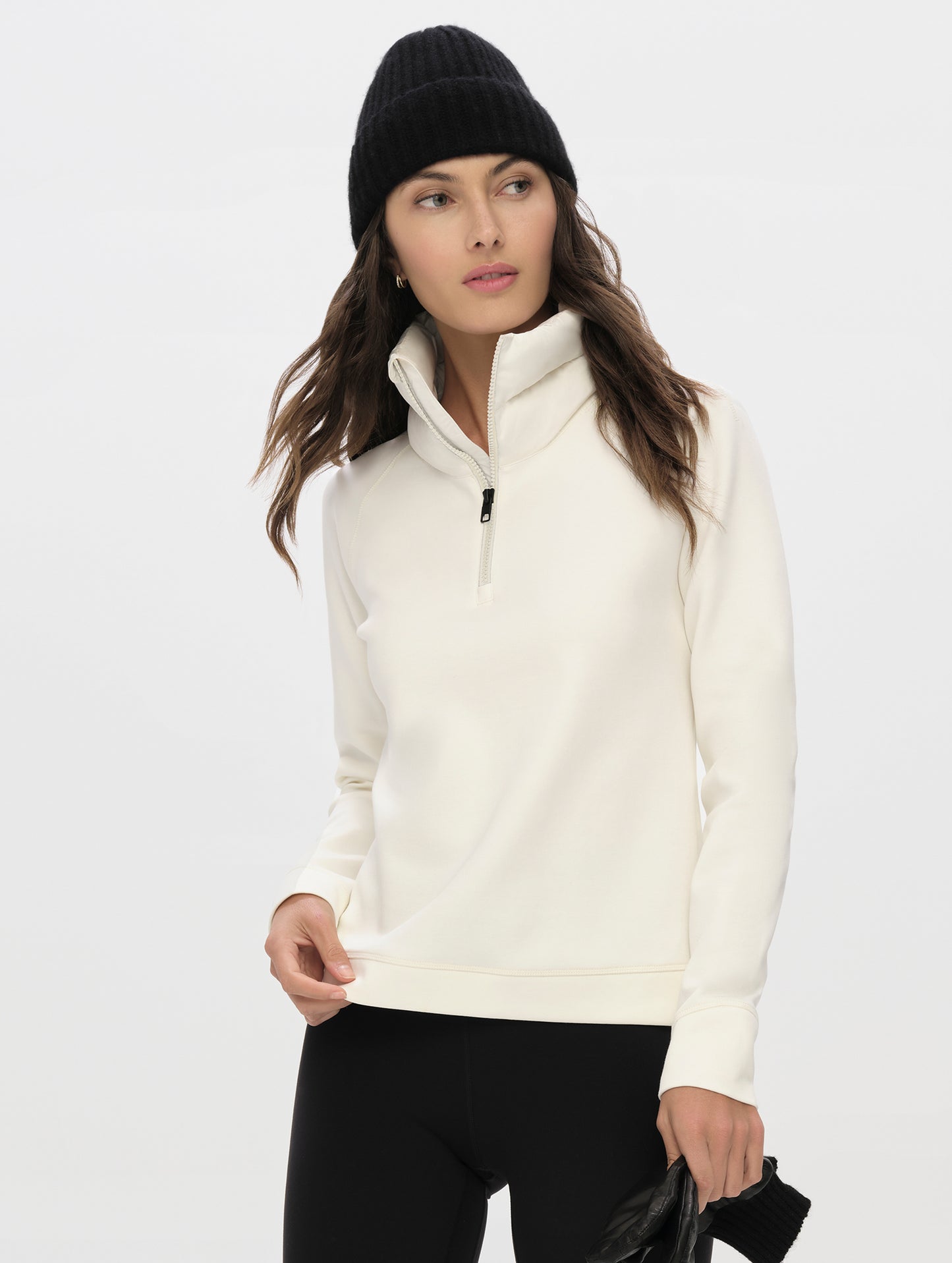 Front, upper-body view of woman wearing the Align Half-Zip Pullover in Winter White from AETHER Apparel.
