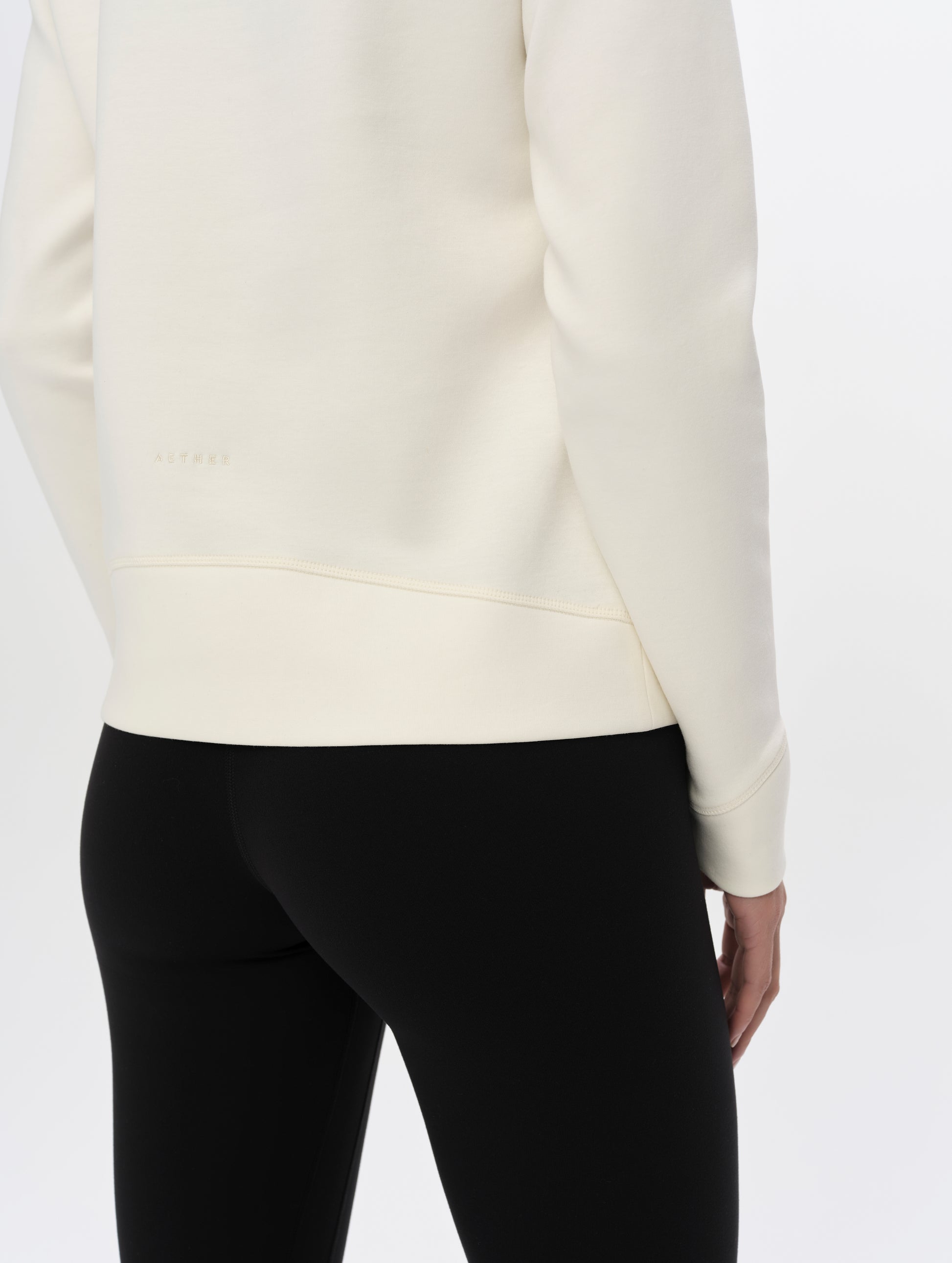 Closeup detailed view of the back of the Align Half-Zip Pullover in Winter White from AETHER Apparel.