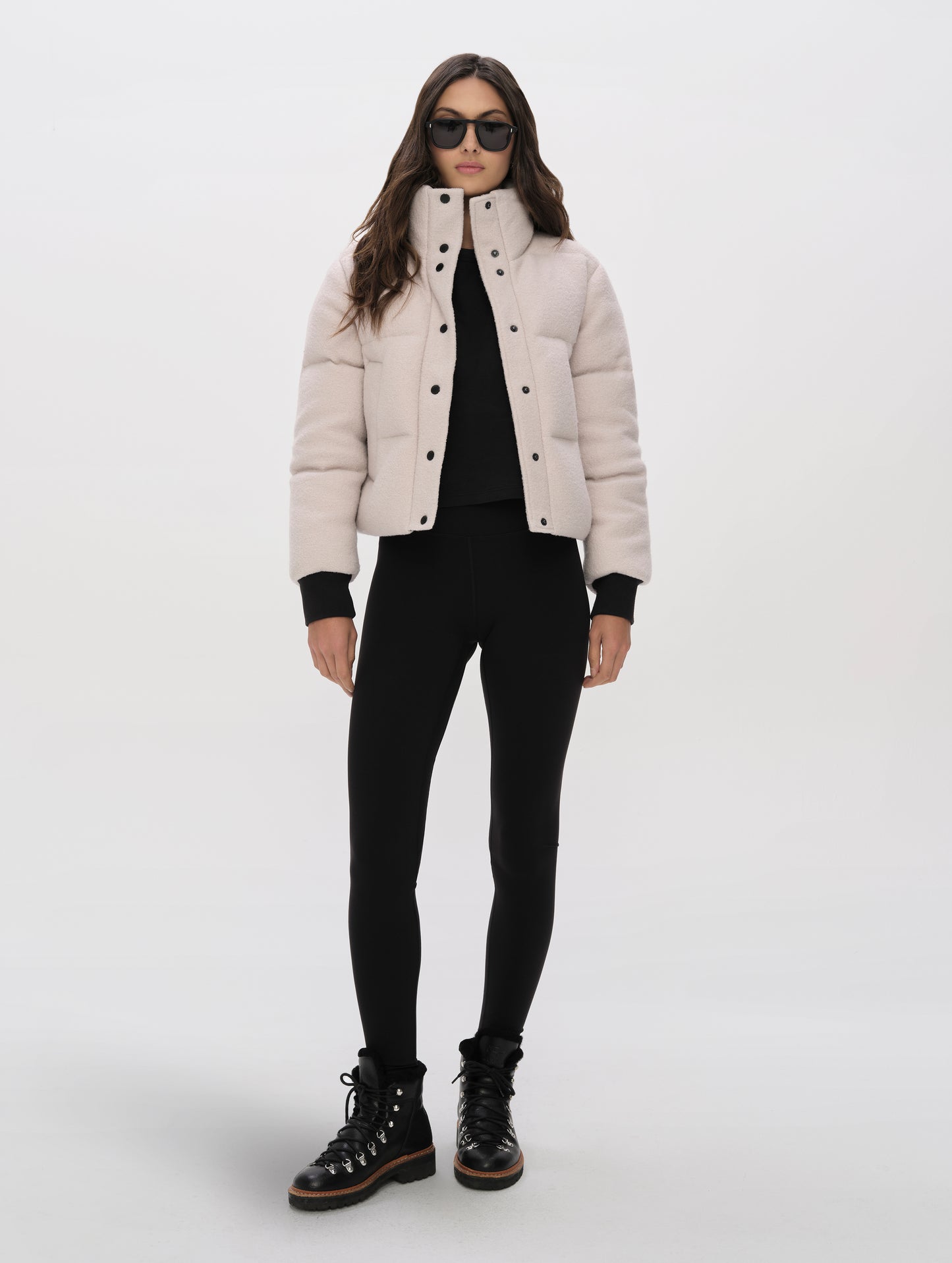 Front full-body view of woman wearing the Aura Puffer Jacket Wool in Bone white from AETHER Apparel.