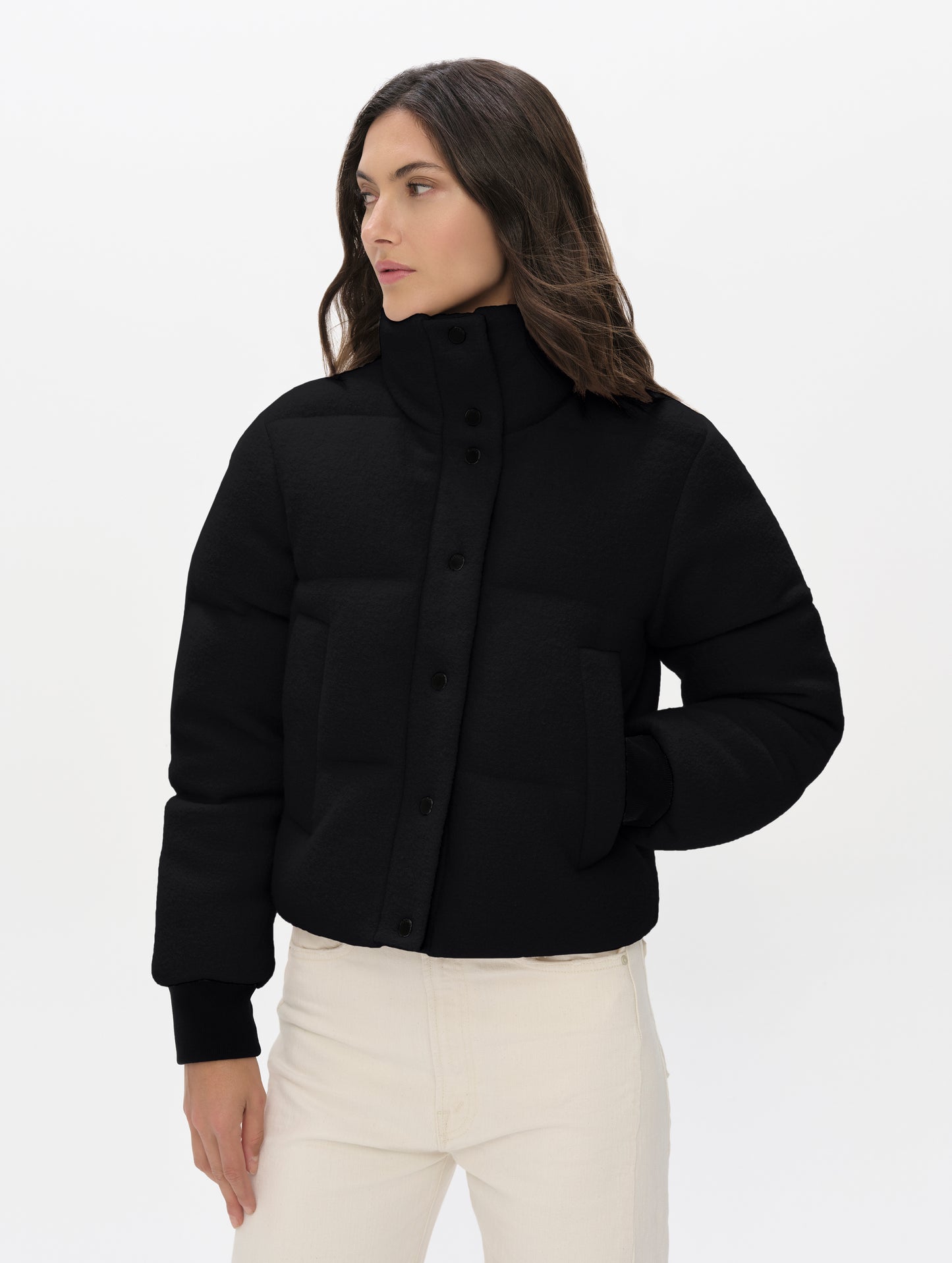 Front upper-body view of woman wearing the Aura Puffer Jacket Wool in Onyx Black from AETHER Apparel.