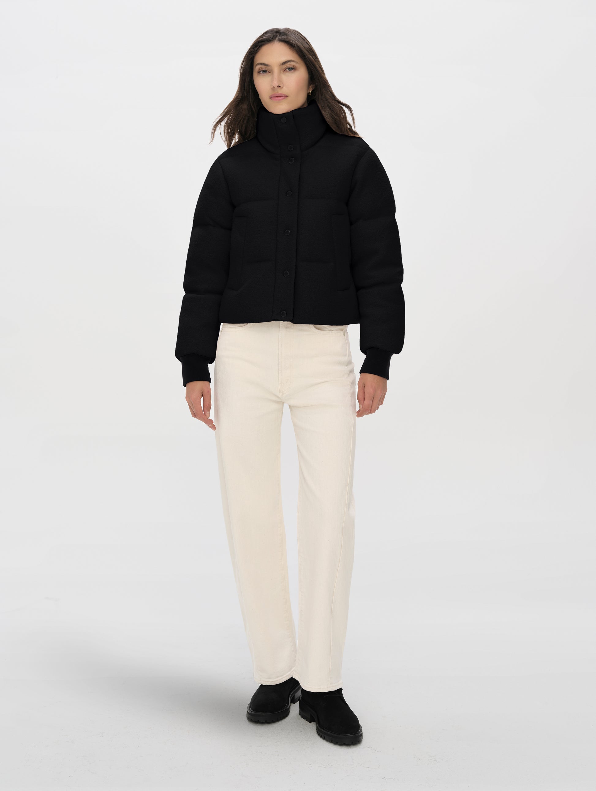 Front full-body view of woman wearing the Aura Puffer Jacket Wool in Onyx Black from AETHER Apparel.