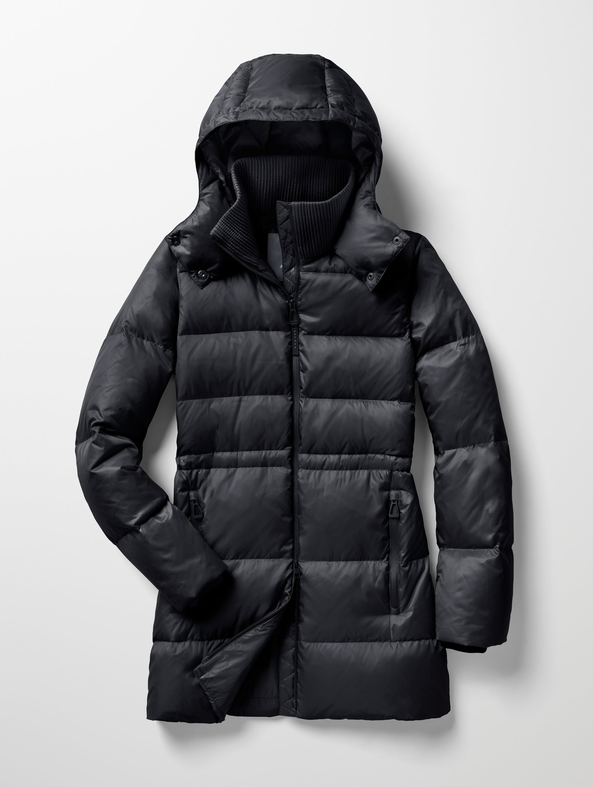 Flat lay of women's Aura Puffer Long in Onyx Black from AETHER Apparel.