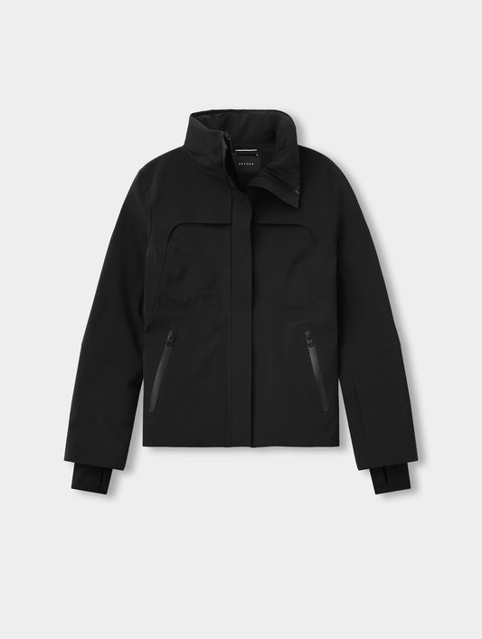 Side profile of a model in the Aurora Insulated Snow Jacket in Onyx Black, showing the hood and zippered hand pocket.
