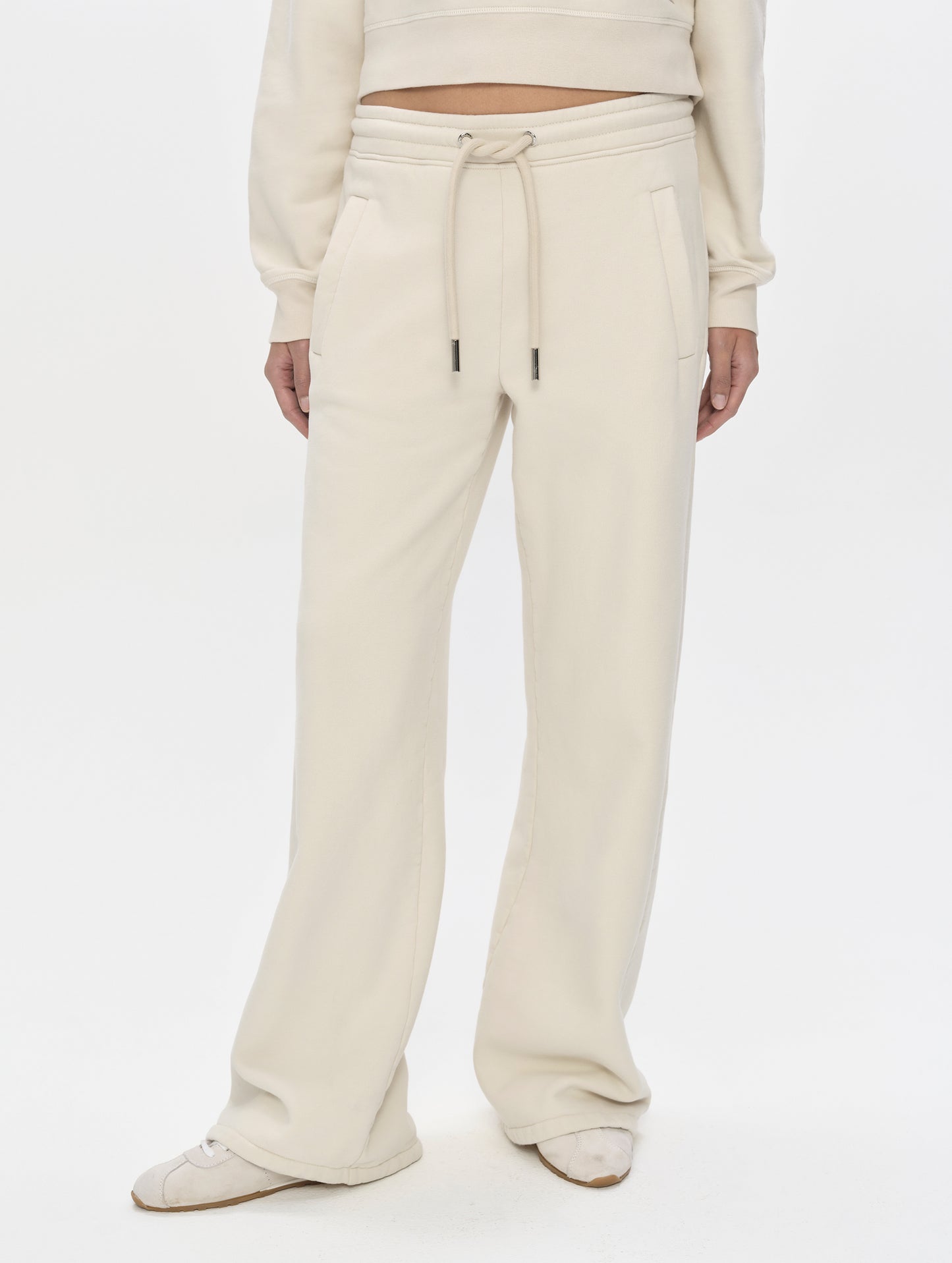 Front, lower-body view of woman wearing the Ayla Wide-Leg Sweatpant in Bone from AETHER Apparel.