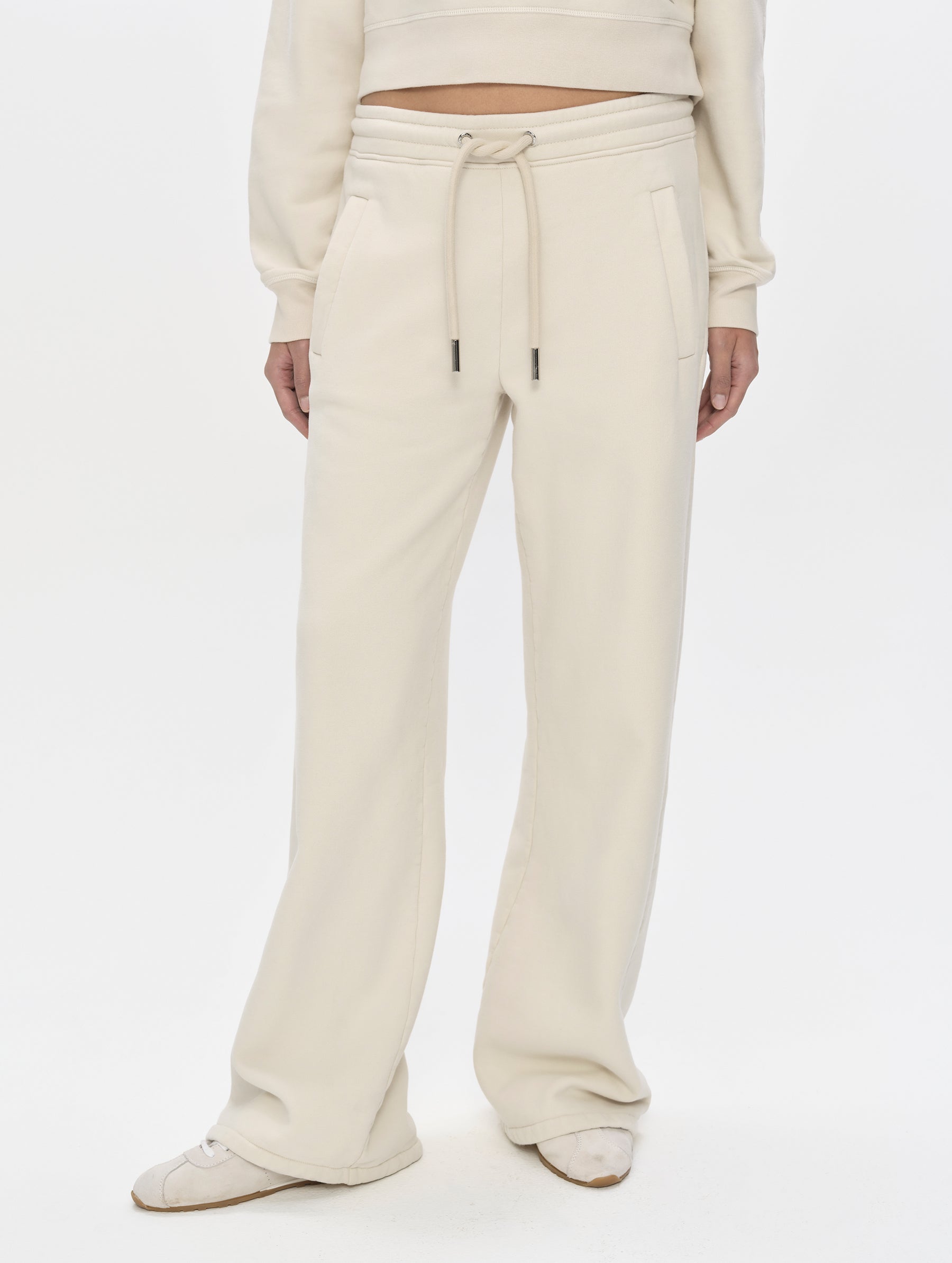 Front, lower-body view of woman wearing the Ayla Wide-Leg Sweatpant in Bone from AETHER Apparel.