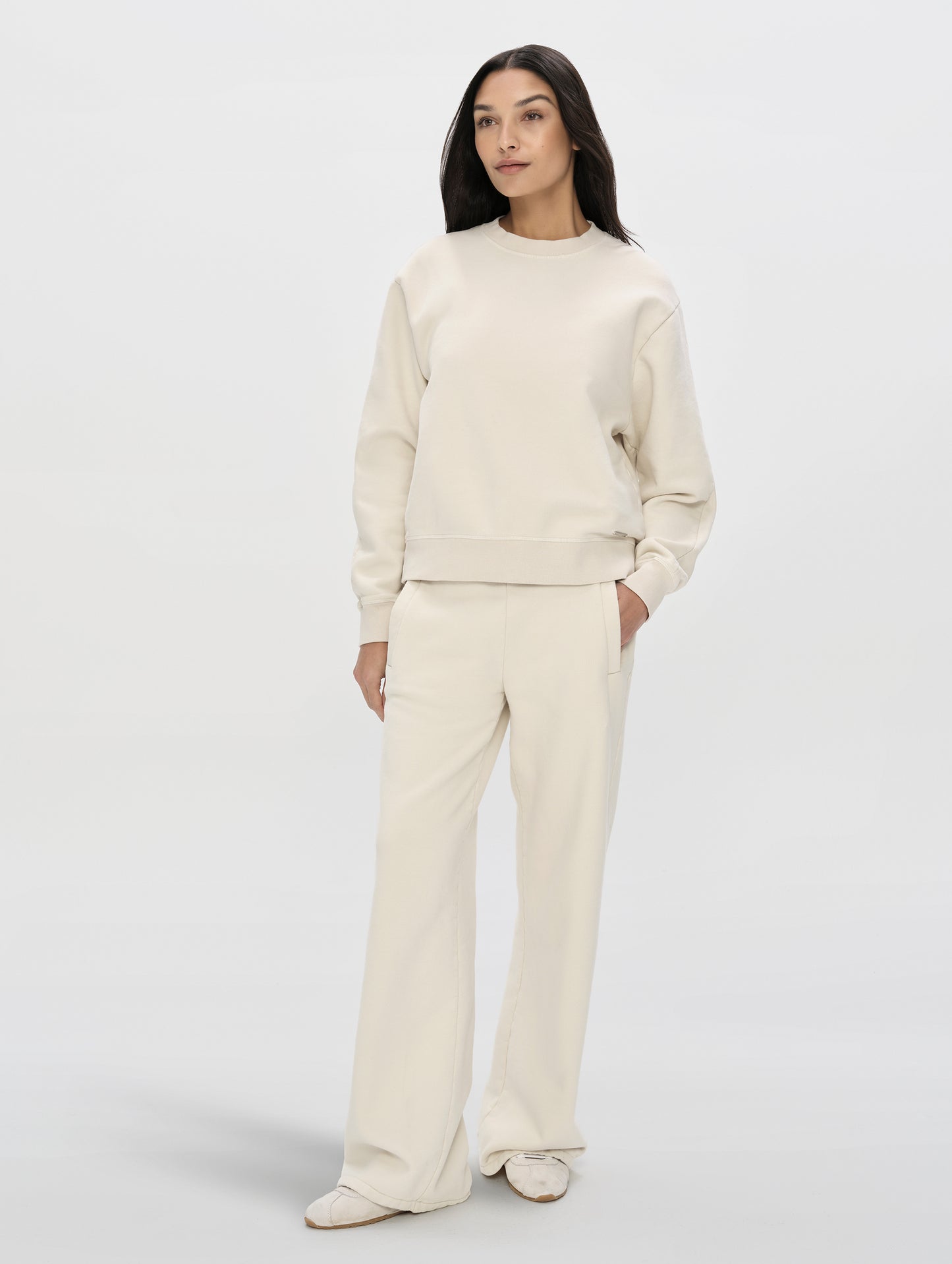 Front, full-body view of woman wearing the Ayla Wide-Leg Sweatpant in Bone from AETHER Apparel.
