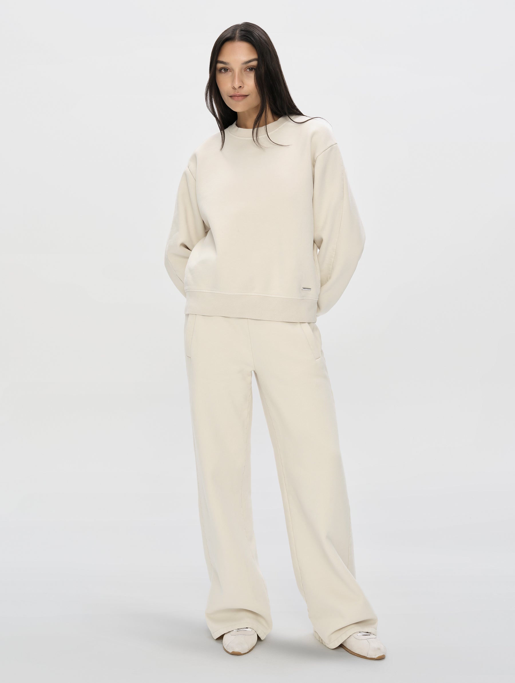 Front, full-body view of woman wearing the Ayla Crewneck Sweatshirt in Bone from AETHER Apparel.