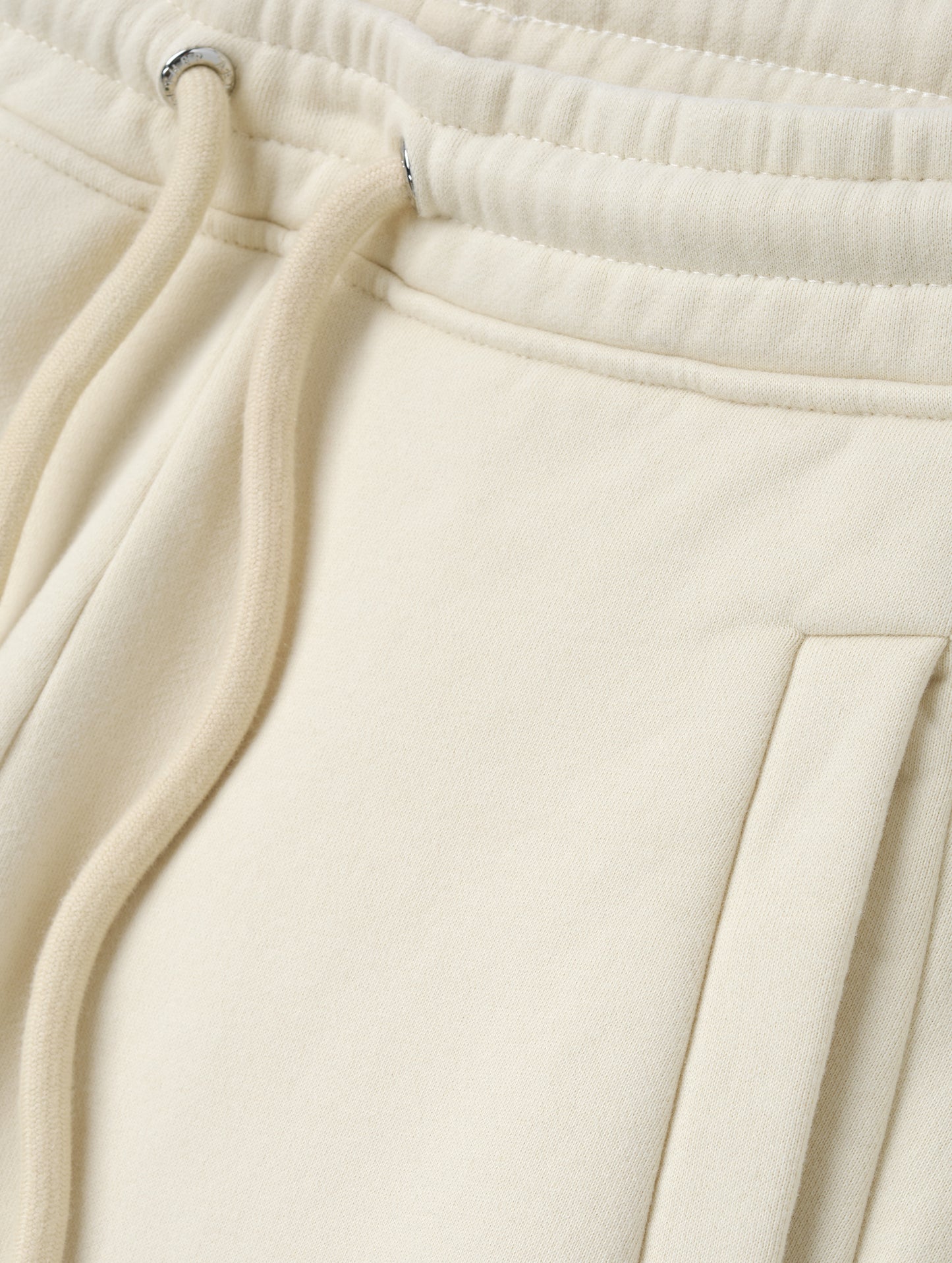 Closeup detailed view of the drawstring closure on the Ayla Wide-Leg Sweatpant in Bone from AETHER Apparel.