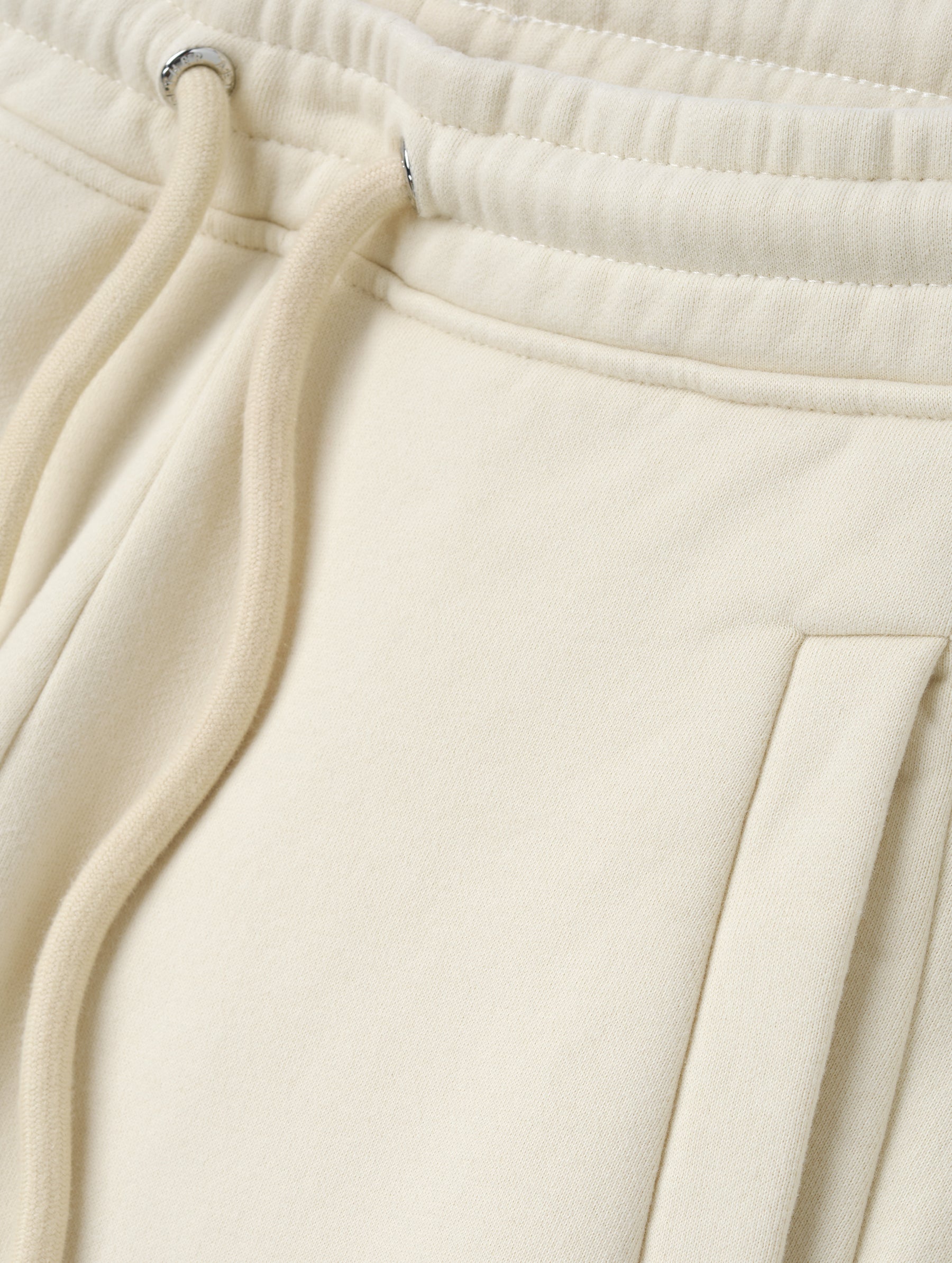Closeup detailed view of the drawstring closure on the Ayla Wide-Leg Sweatpant in Bone from AETHER Apparel.