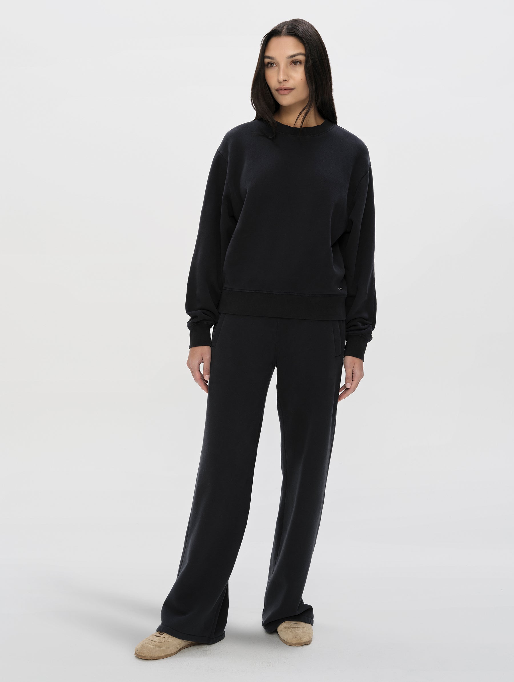Front, full-body view of woman wearing the Ayla Crewneck Sweatshirt in Onyx Black from AETHER Apparel.