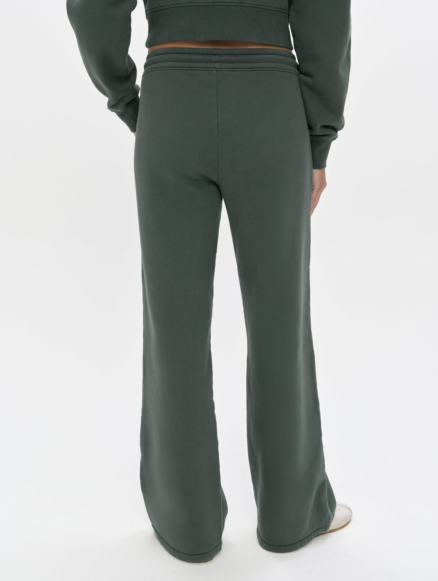 Rear, lower-body view of woman wearing the Ayla Wide-Leg Sweatpant in Saville Green from AETHER Apparel.