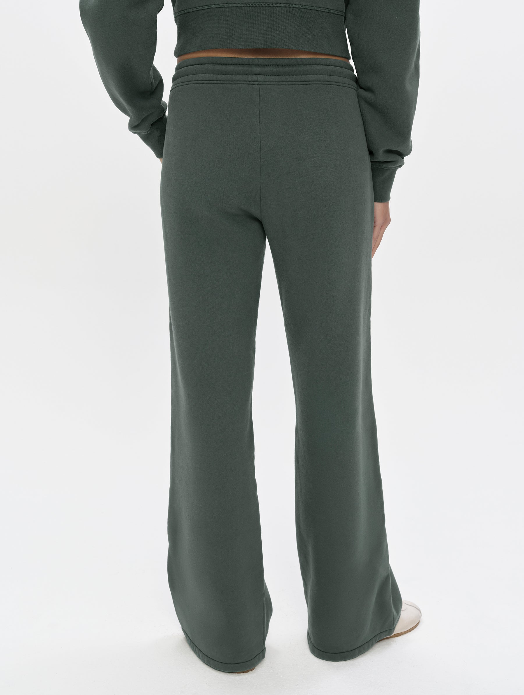 Rear, lower-body view of woman wearing the Ayla Wide-Leg Sweatpant in Saville Green from AETHER Apparel.
