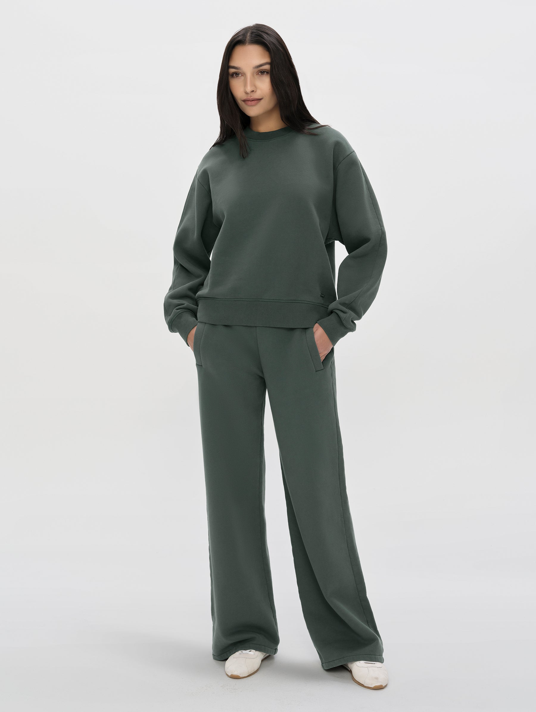Front, full-body view of woman wearing the Ayla Wide-Leg Sweatpant in Saville Green from AETHER Apparel.