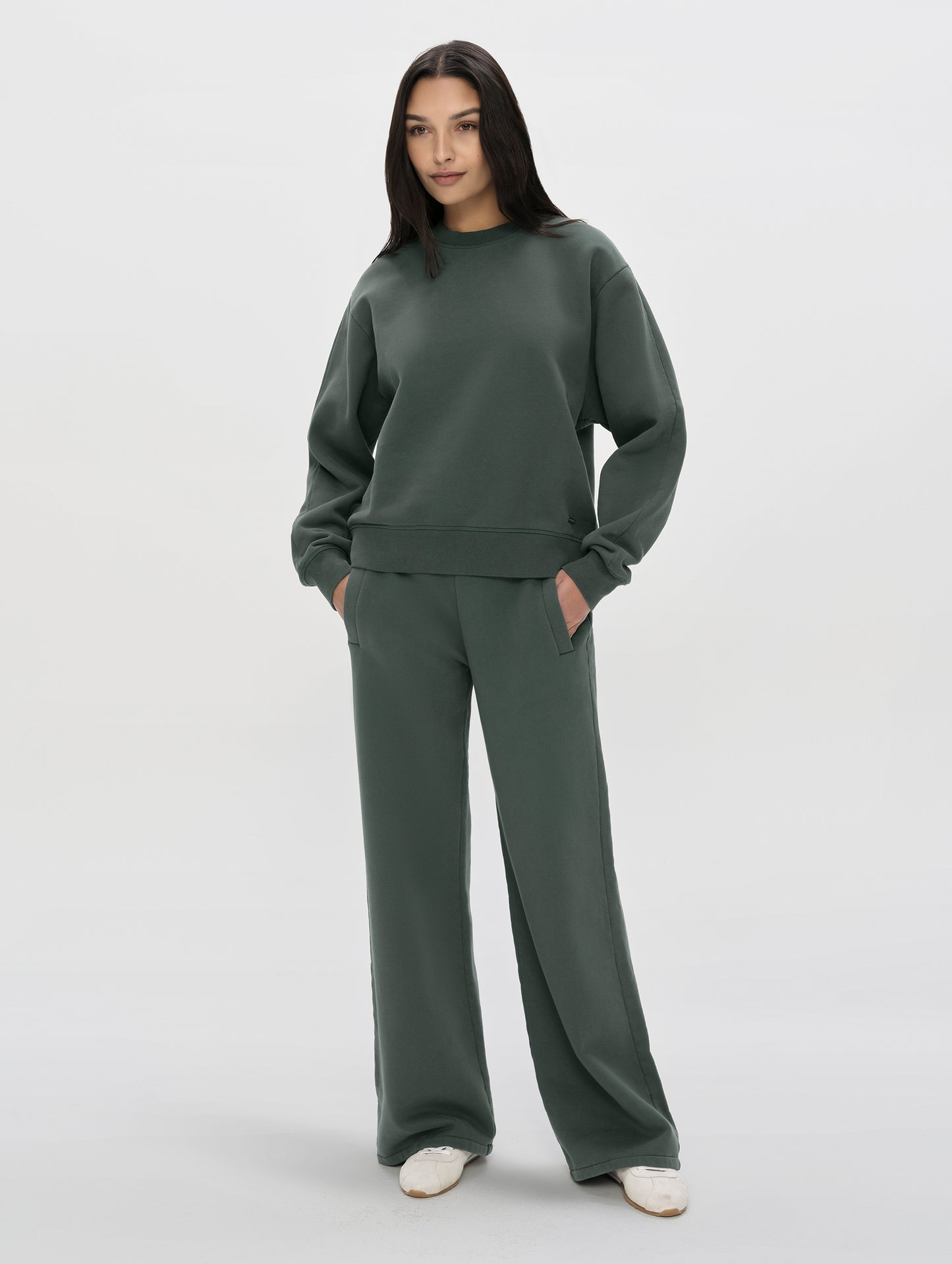 Front, full-body view of woman wearing the Ayla Crewneck Sweatshirt in Saville Green from AETHER Apparel.
