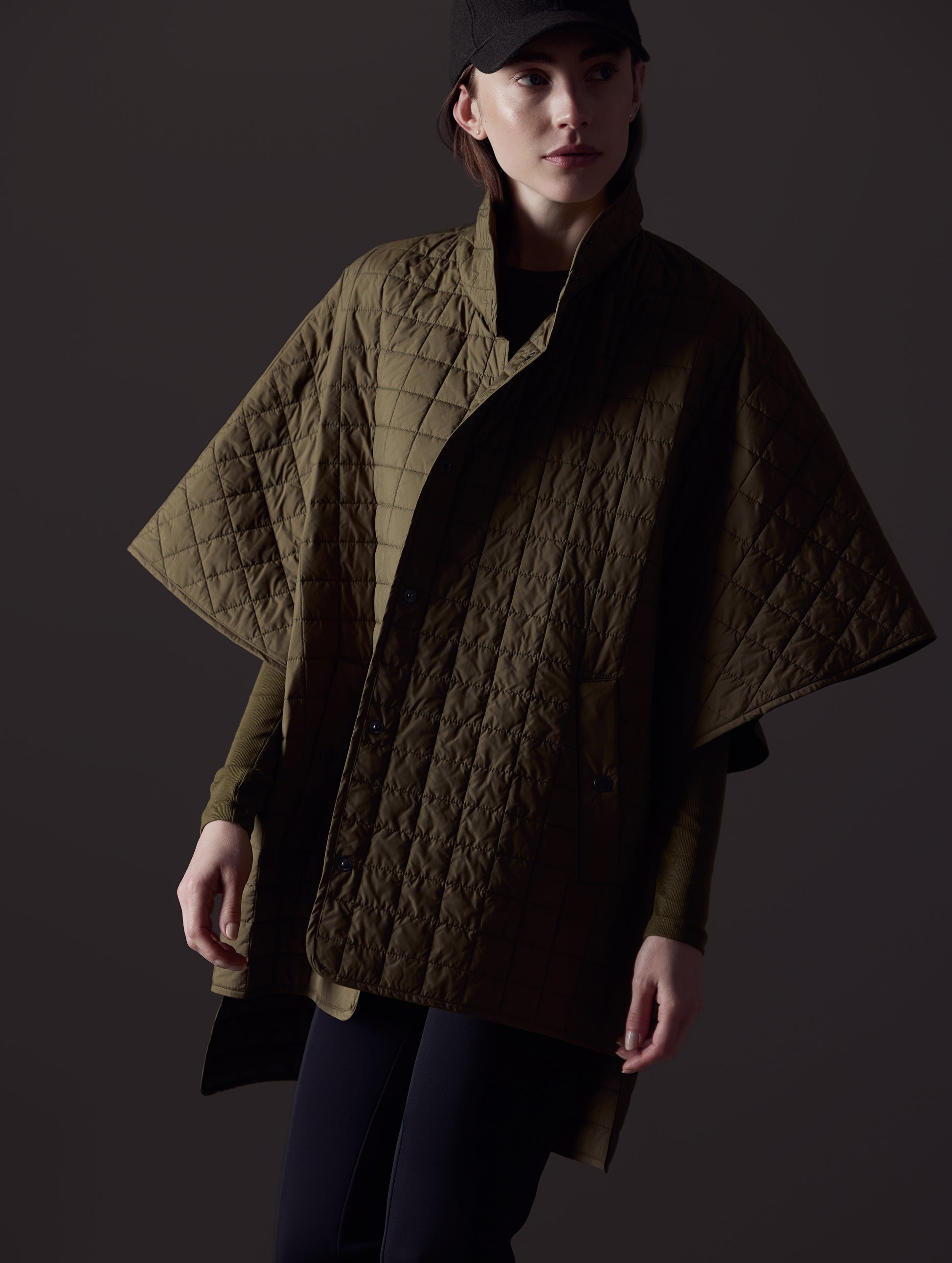 Woman wearing green Bardo Poncho Jacket from AETHER Apparel