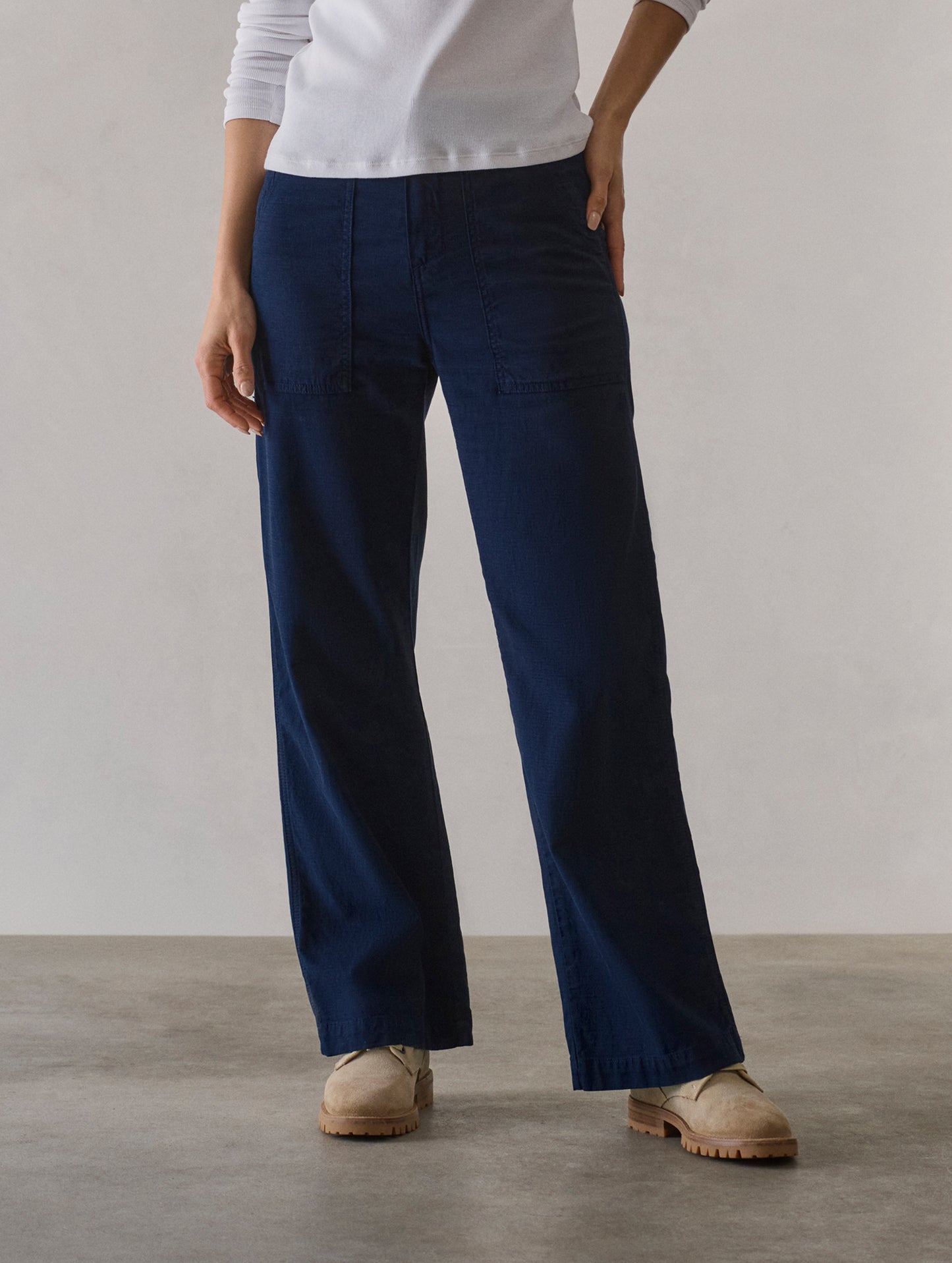 Front lower body view of woman wearing Bella Travel Pant in Nordic Navy from AETHER Apparel.