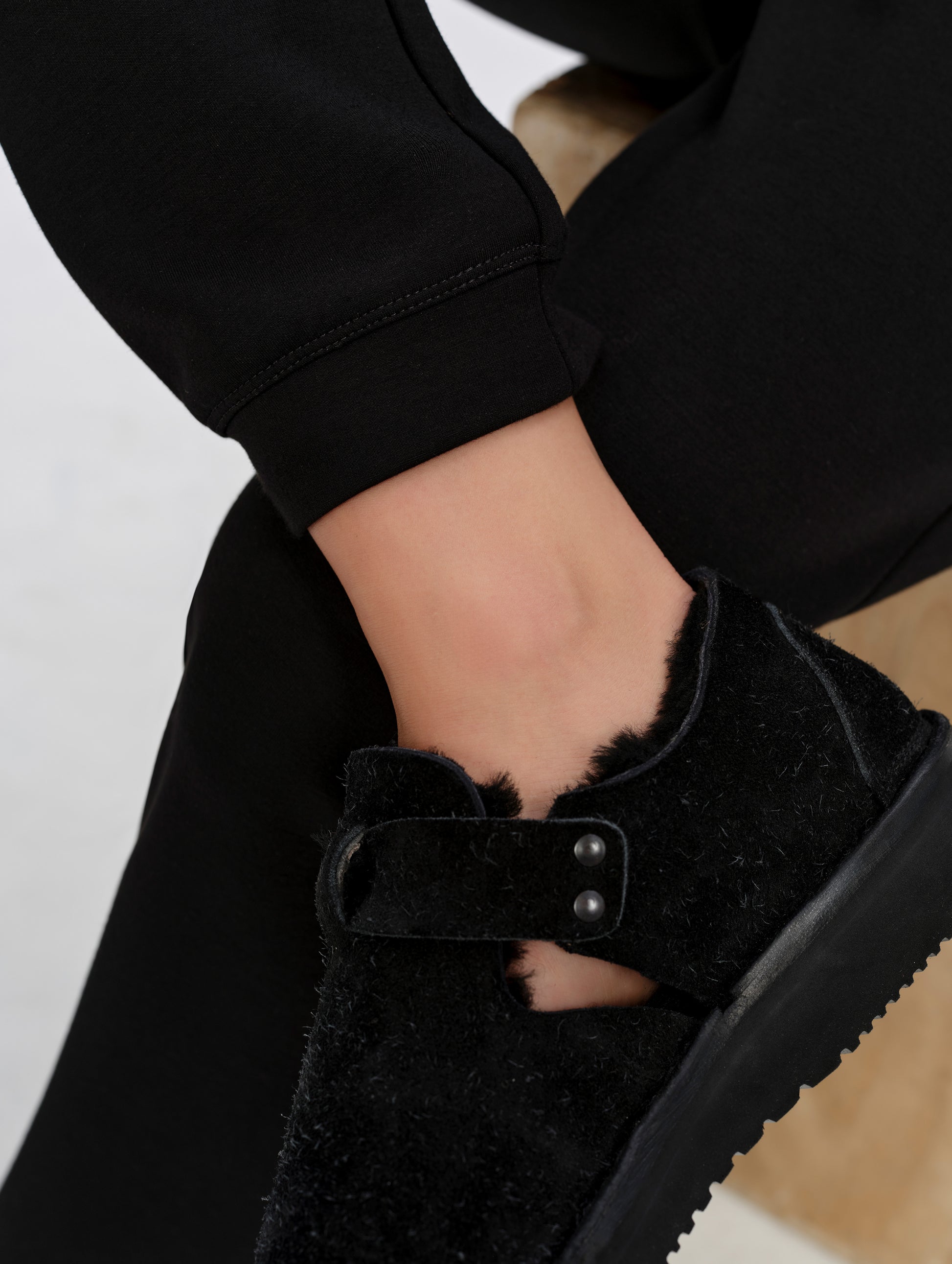 Closeup detailed view of the leg cuff openings on the Blaire Premium Sweatpant in Onyx Black from AETHER Apparel.