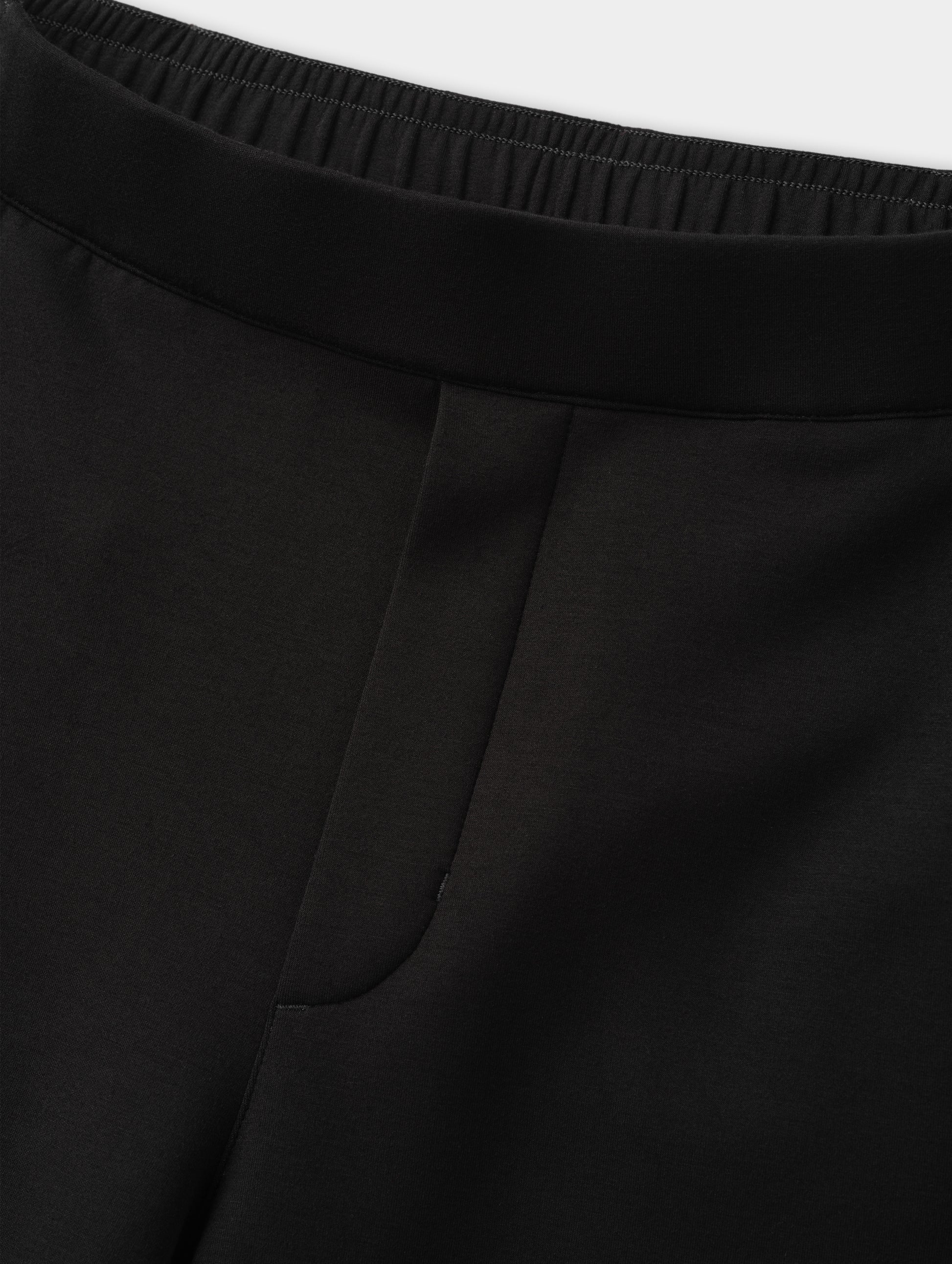 Closeup detailed view of the elasticated waistband and faux fly stitch on the Blaire Premium Sweatpant in Onyx Black from AETHER Apparel.