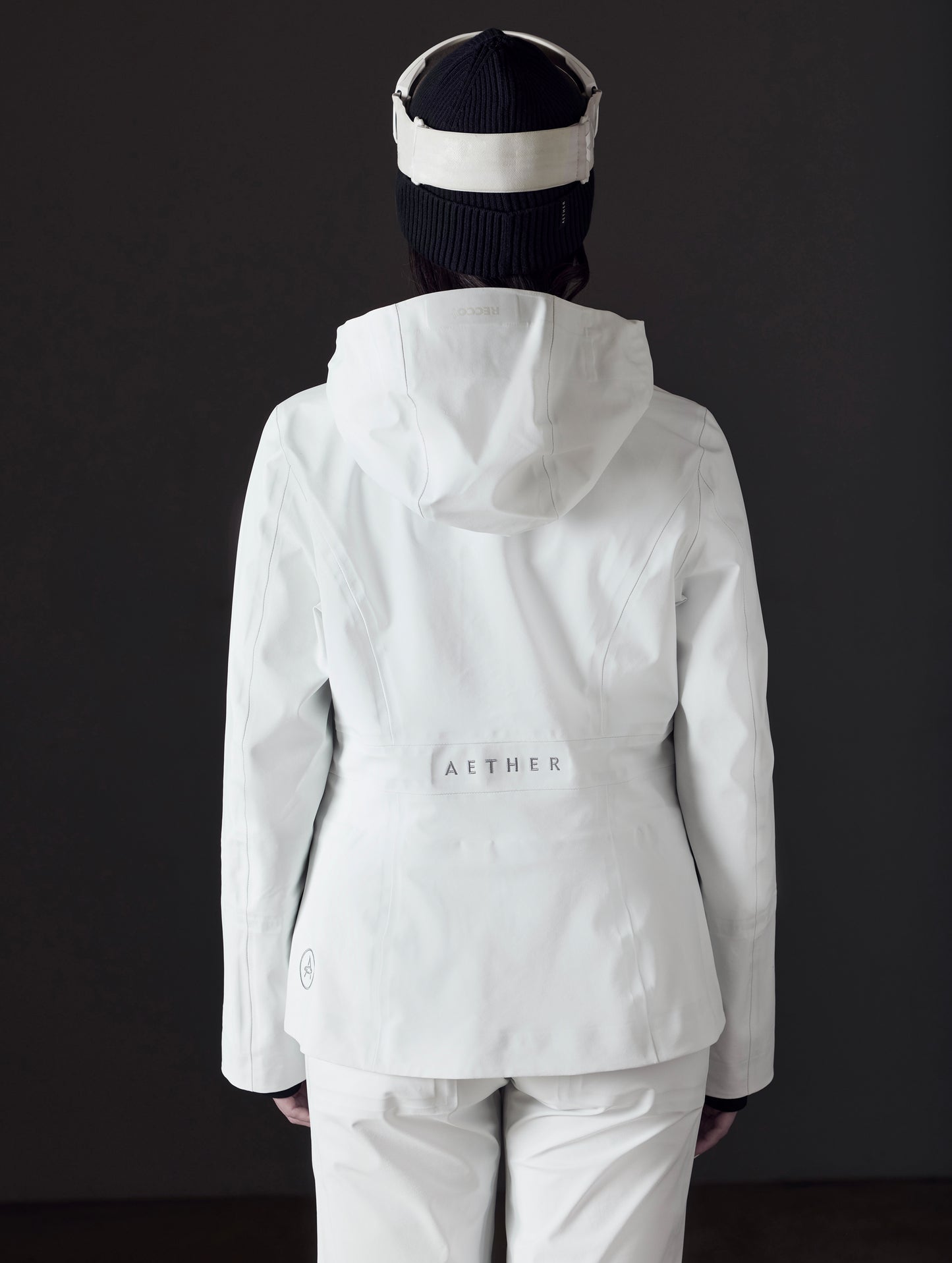 woman wearing white snow jacket from AETHER Apparel