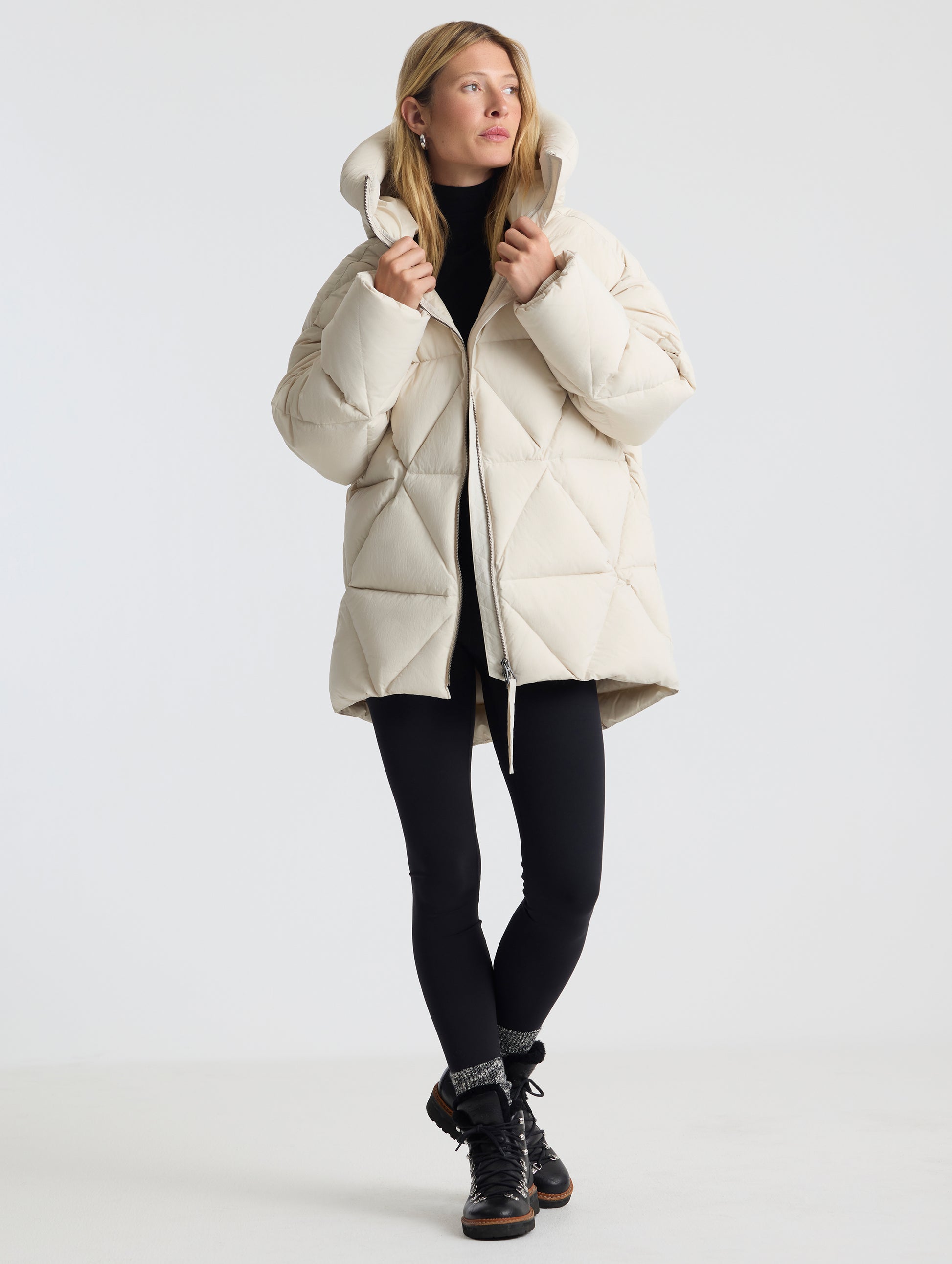Front full-body view of woman wearing the Callie Oversized Down Parka in Bone from AETHER Apparel.