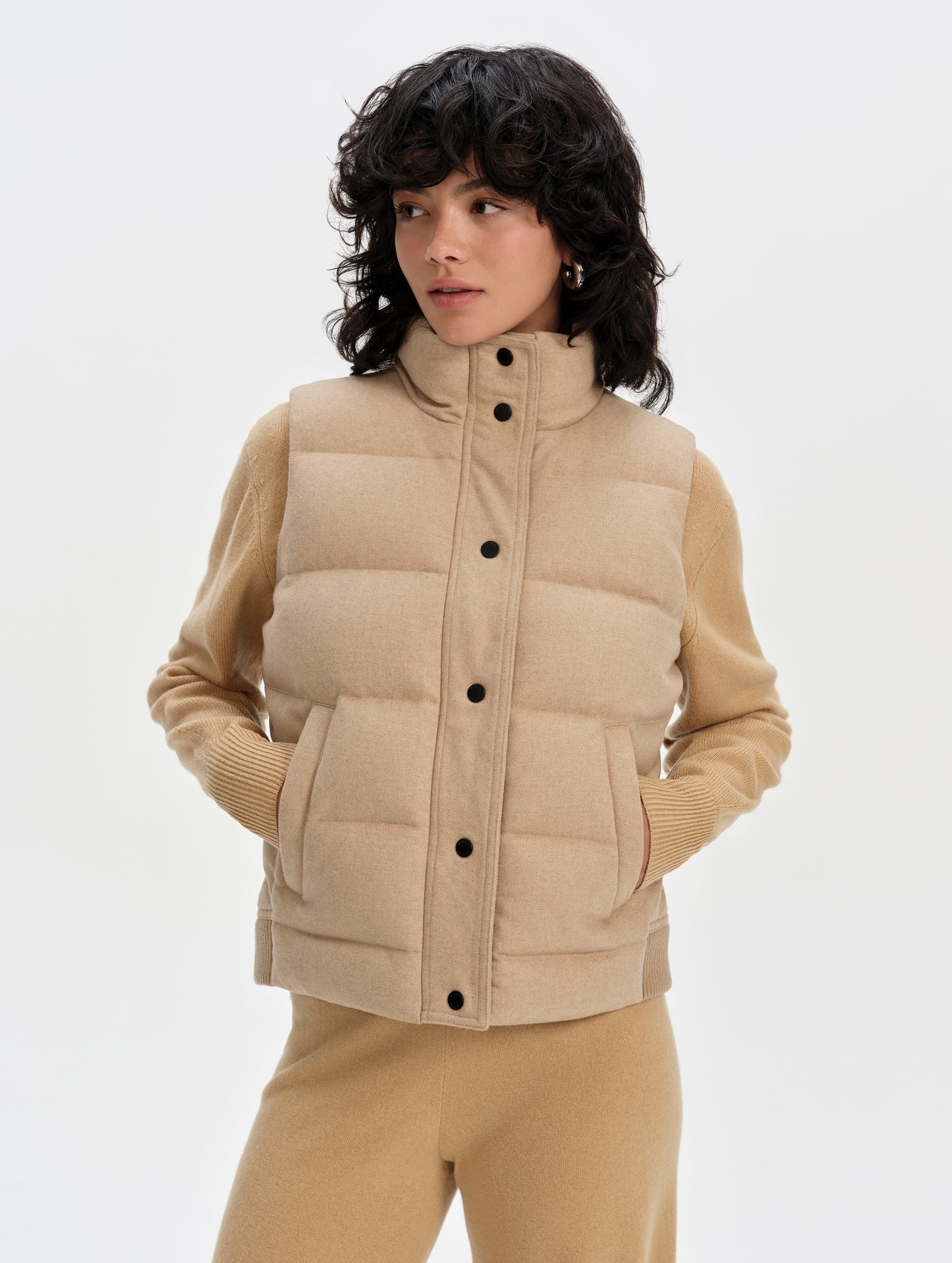 Front upper-body view of woman wearing Channing Vest 2.0 in Latte Brown from AETHER Apparel.