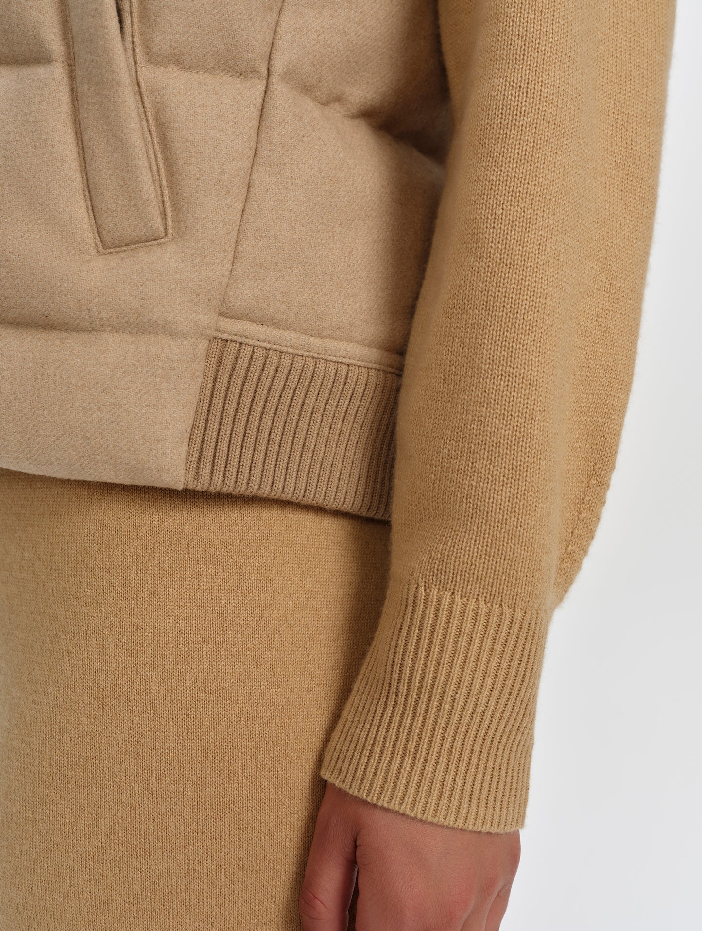 Closeup detailed view of the rib-knit hem on the Channing Vest 2.0 in Latte Brown from AETHER Apparel.