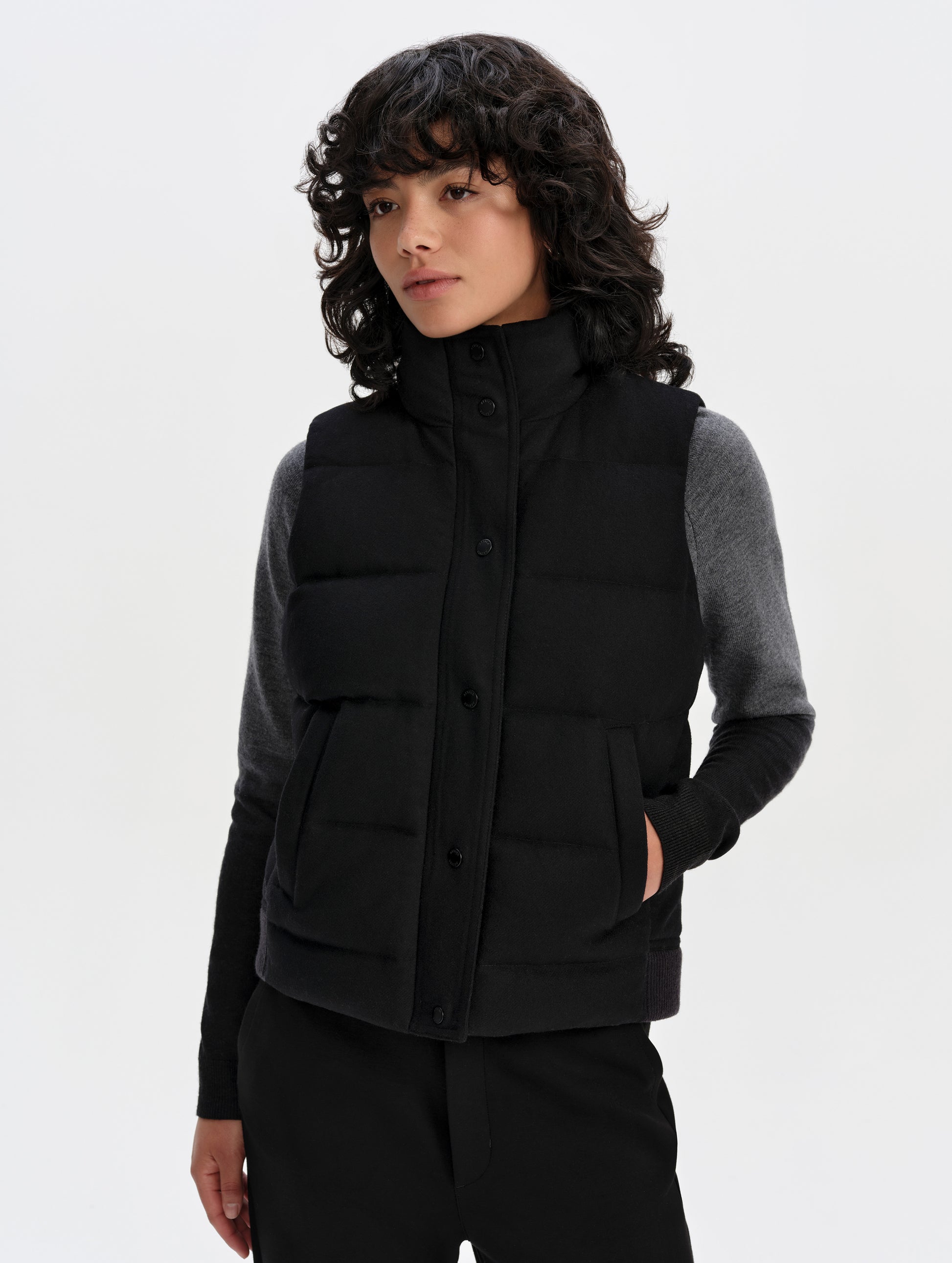 Front upper-body view of woman wearing Channing Vest 2.0 in Onyx Black from AETHER Apparel.