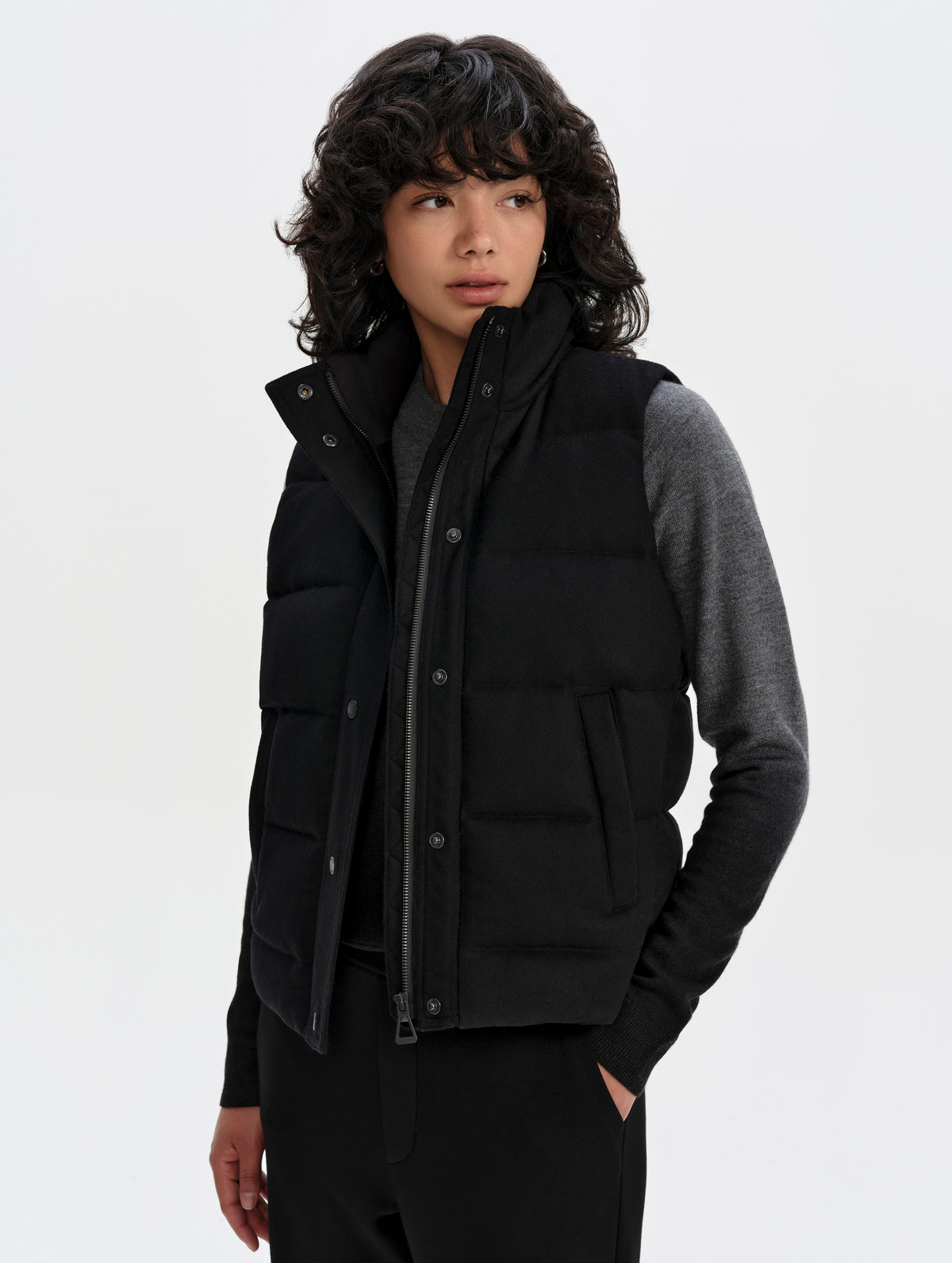 Front 3/4 upper-body view of woman wearing Channing Vest 2.0 in Onyx Black from AETHER Apparel.