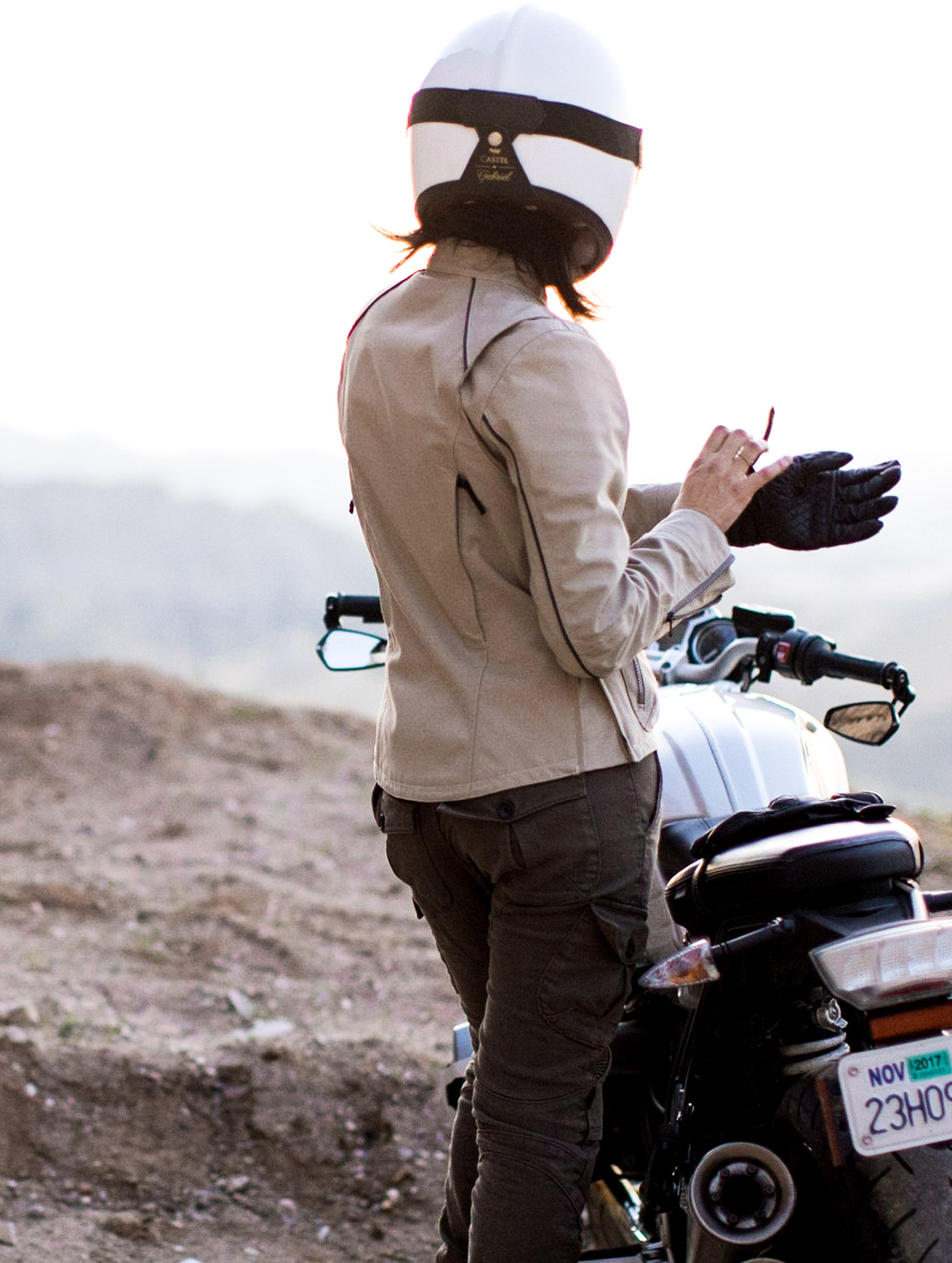 Woman wearing sand Chase Motorcycle Jacket from AETHER Apparel