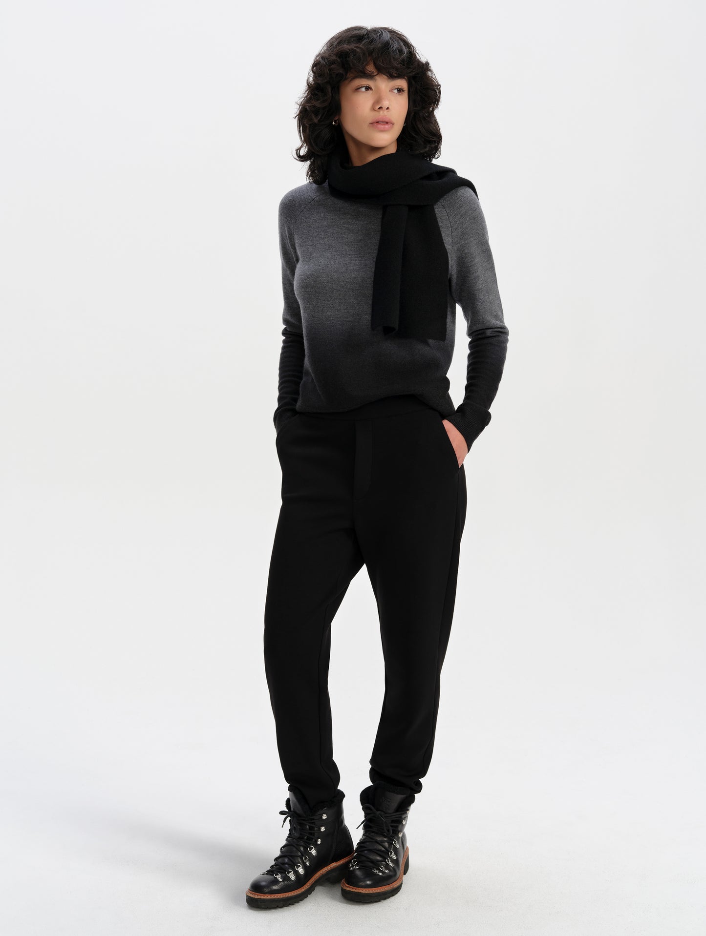 Front full-body view of woman wearing the Dash Ombre Sweater in Charcoal Grey from AETHER Apparel.