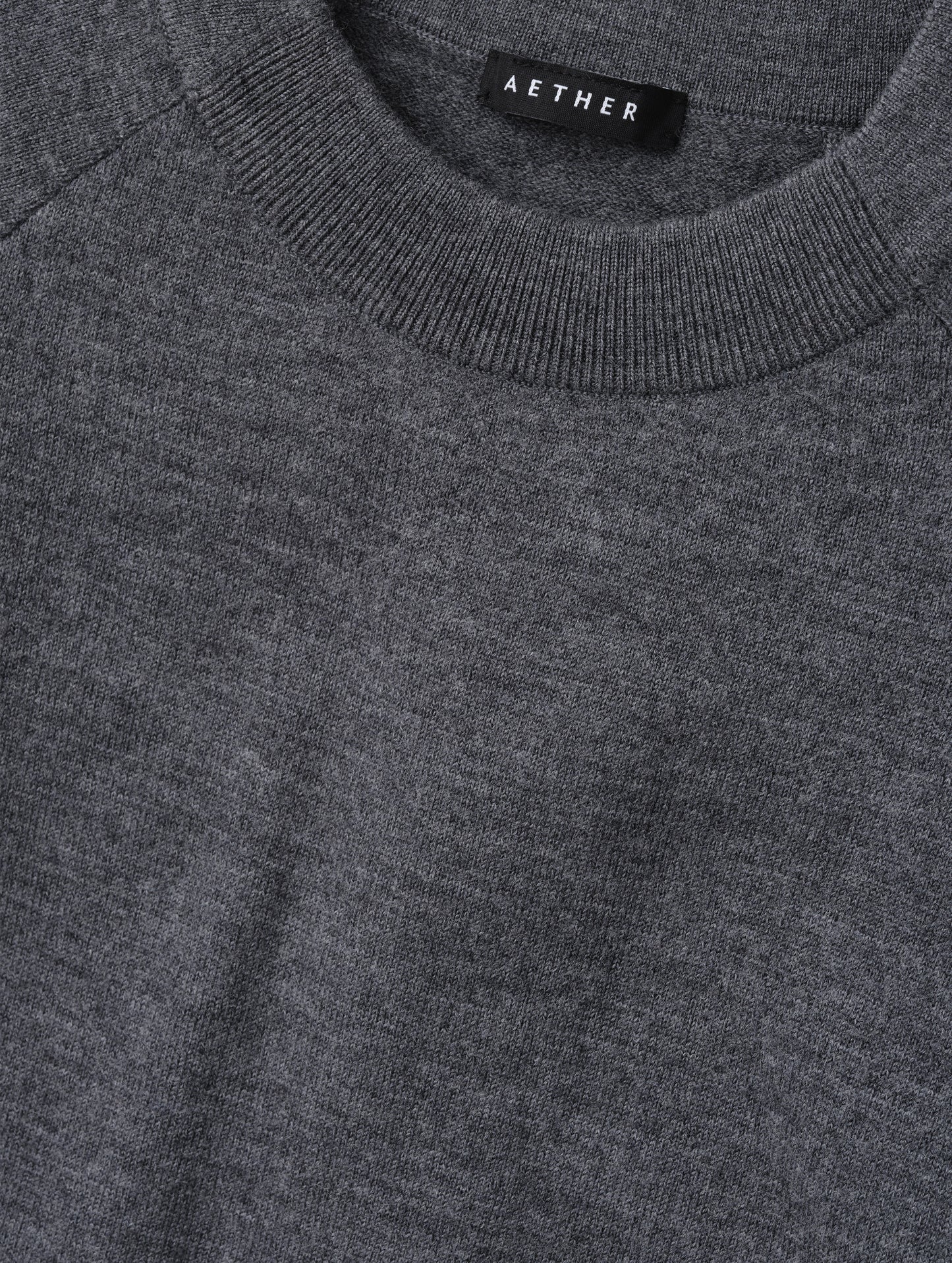 Closeup detailed view of the pieced in collar with rib knit front on the Dash Ombre Sweater in Charcoal Grey from AETHER Apparel.