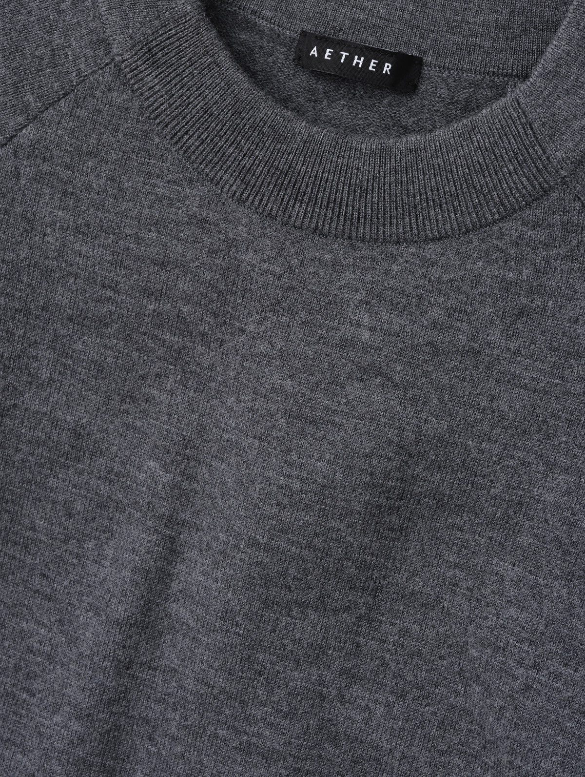Closeup detailed view of the pieced in collar with rib knit front on the Dash Ombre Sweater in Charcoal Grey from AETHER Apparel.