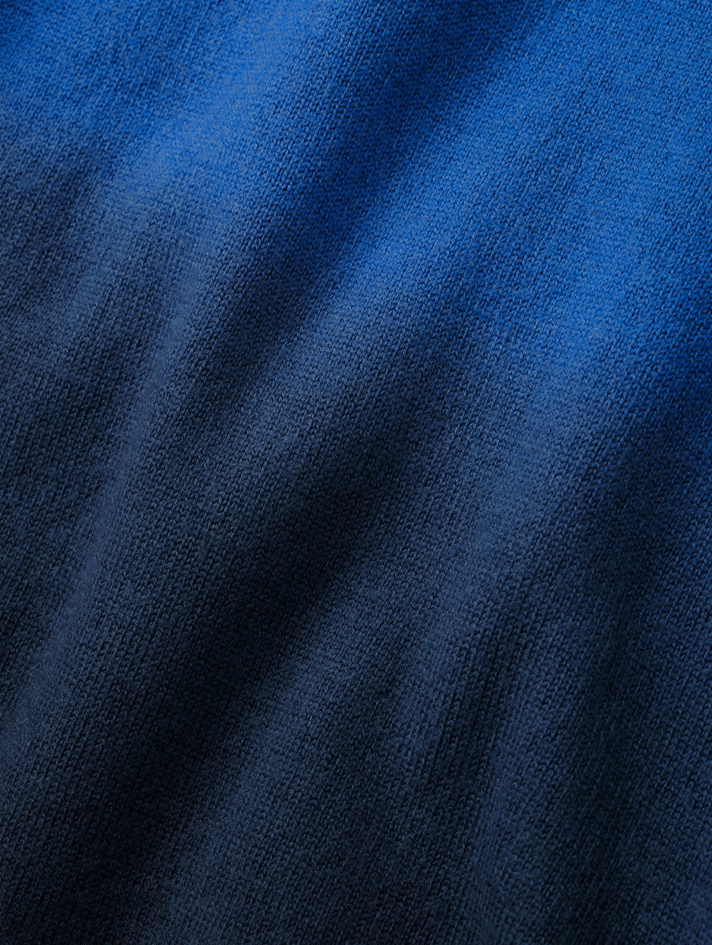 Closeup detailed view of the two-tone dip-dyed colorway on the Dash Ombre Sweater in Galaxy Blue from AETHER Apparel.