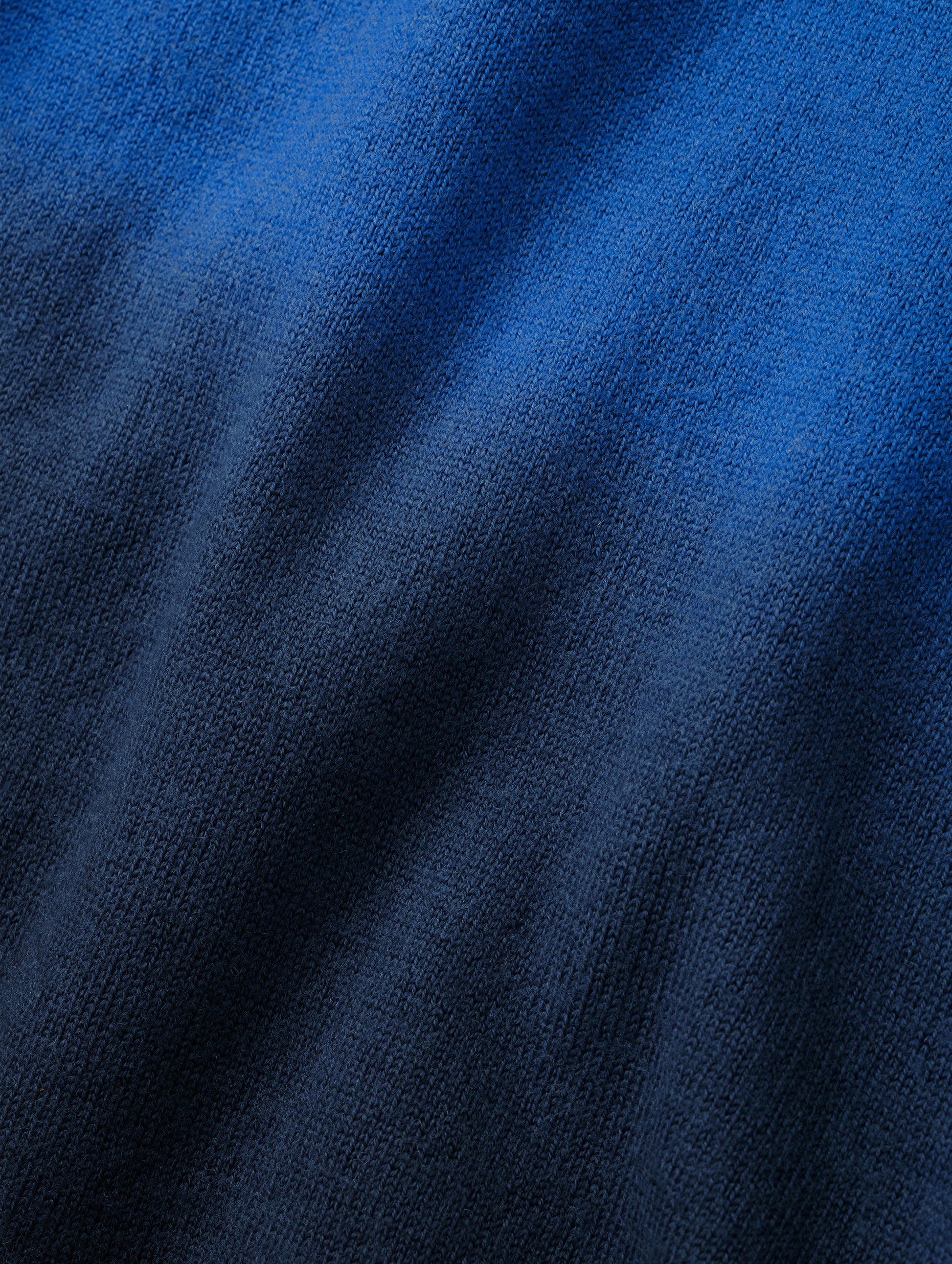 Closeup detailed view of the two-tone dip-dyed colorway on the Dash Ombre Sweater in Galaxy Blue from AETHER Apparel.