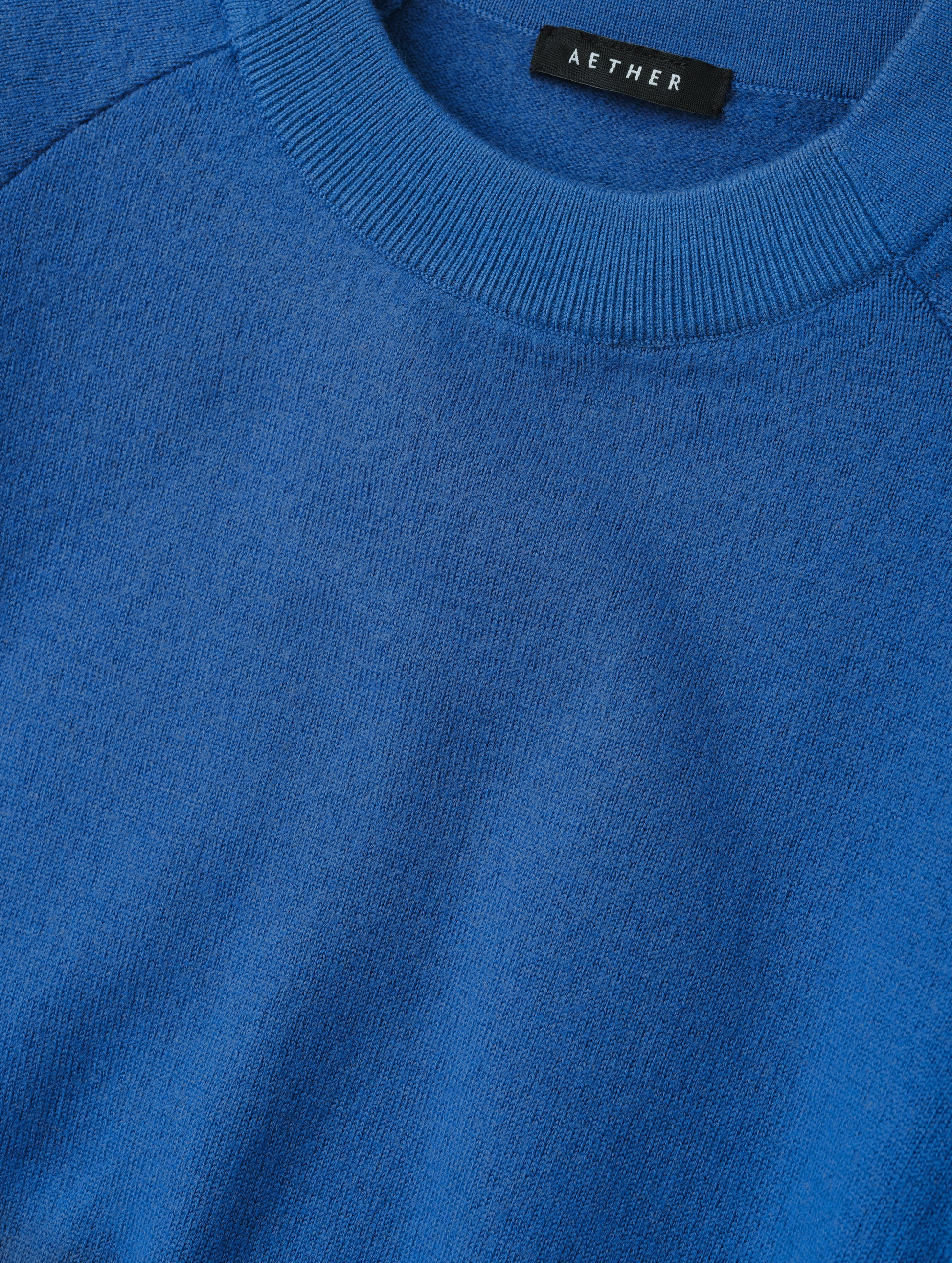 Closeup detailed view of the pieced in collar with rib knit front on the Dash Ombre Sweater in Galaxy Blue from AETHER Apparel.