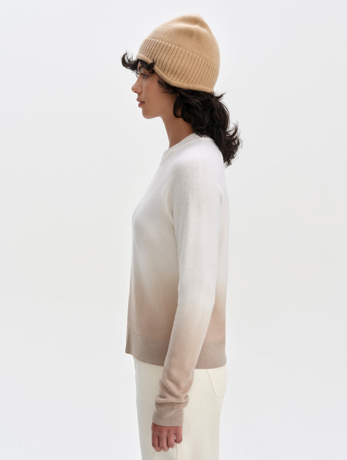 Side profile upper-body view of woman wearing the Dash Ombre Sweater in Winter White from AETHER Apparel.