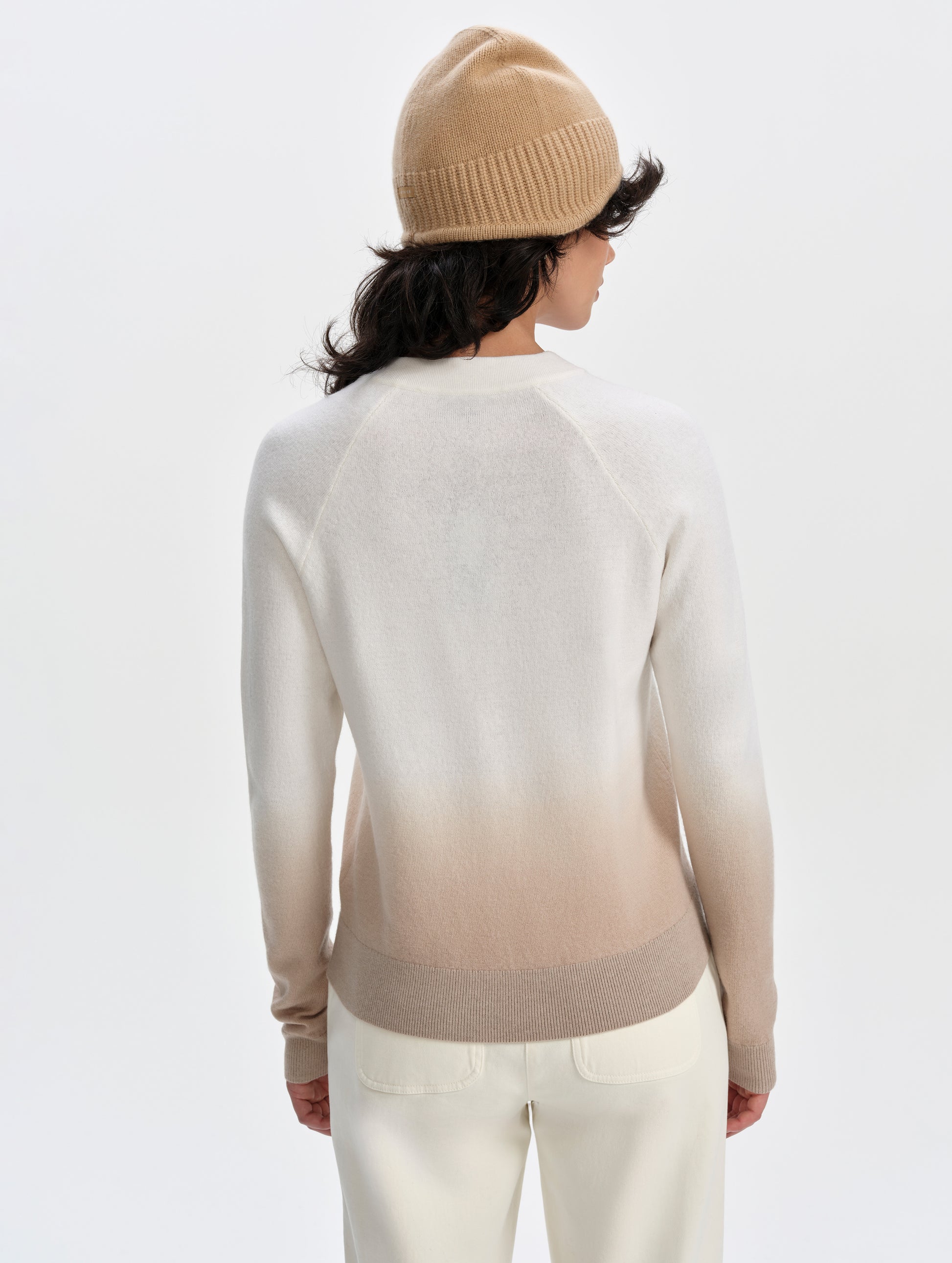 Rear upper-body view of woman wearing the Dash Ombre Sweater in Winter White from AETHER Apparel.